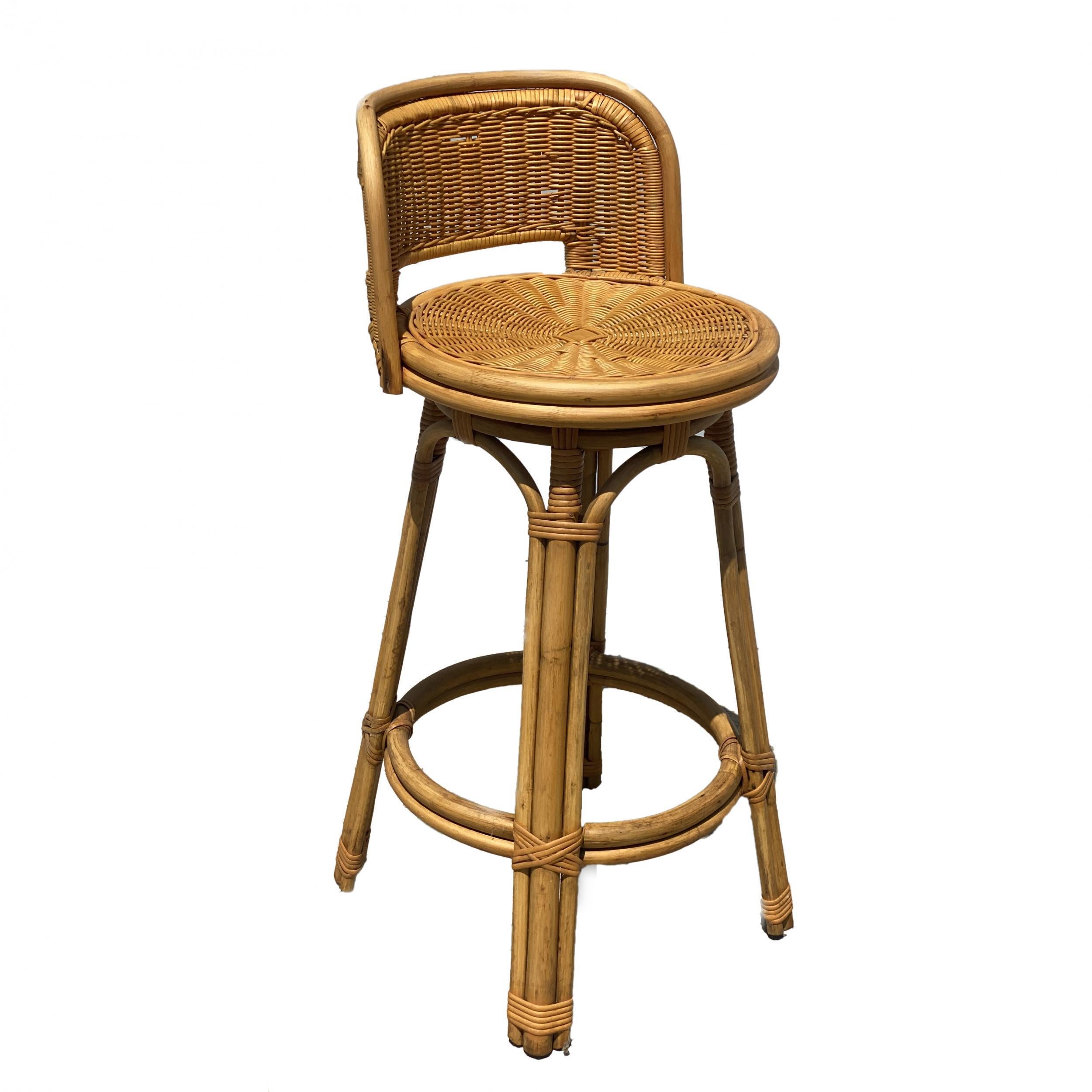 Circa 1950 set of 3 rattan bar stools with woven wicker seats and 3 strand rattan pull legs. Each stool comes with a full formed back rest complimented by arches connecting each leg. 

Measures: Height- 38