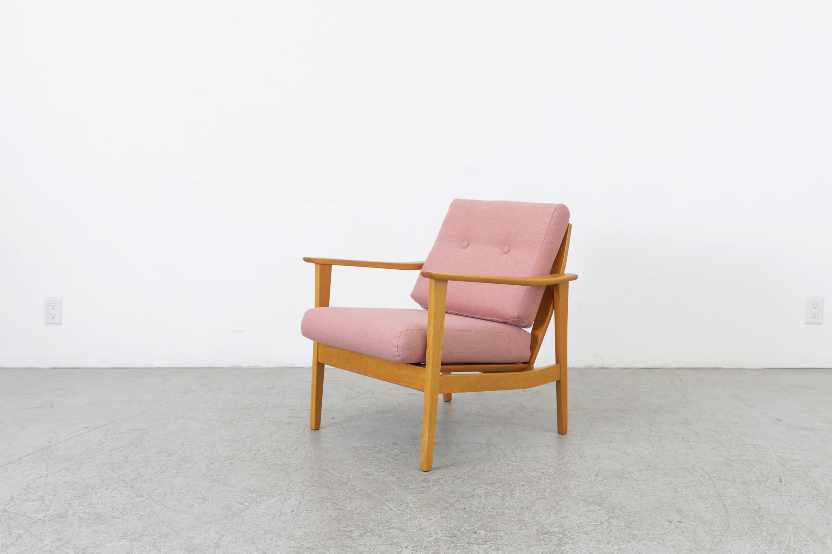Mid-century blonde wood lounge chair by Knoll with an exposed wood slatted back support and newer pink upholstered cushions. The frame is in good original condition with normal wear consistent with its age and use. A similar set of lounge chairs are
