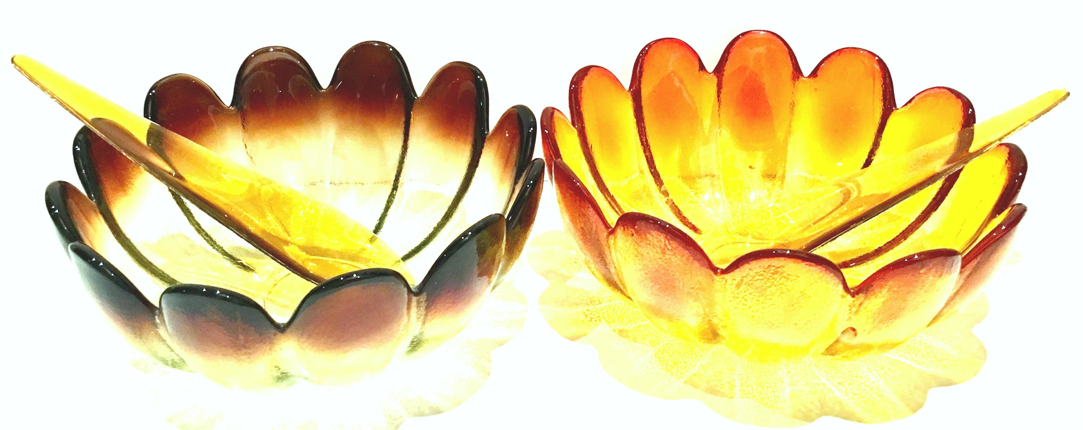 Mid-20thcentury pair of American blown glass petal-form serving bowls and Amberina Lucite salad serving fork and spoon set of four pieces by, The Indiana Glass Company. This four piece set includes, one large petal bowl in amber 