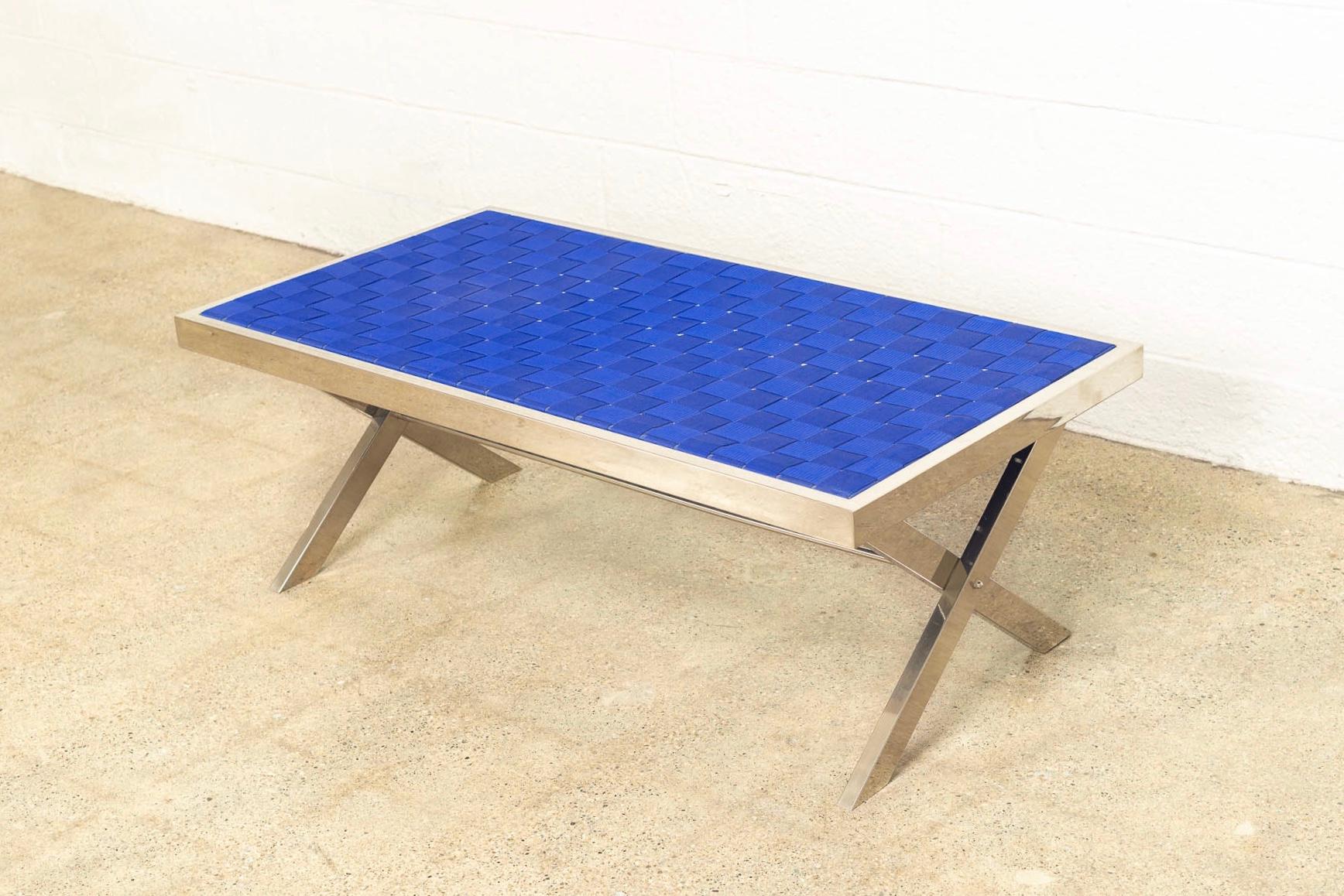 This vintage Mid-Century Modern Milo Baughman style chrome and strap bench is circa 1980. The clean, minimalist design features a chrome frame with crossed x-base and a woven heavy strap seat in a striking shade of royal blue. Use as a seat bench or