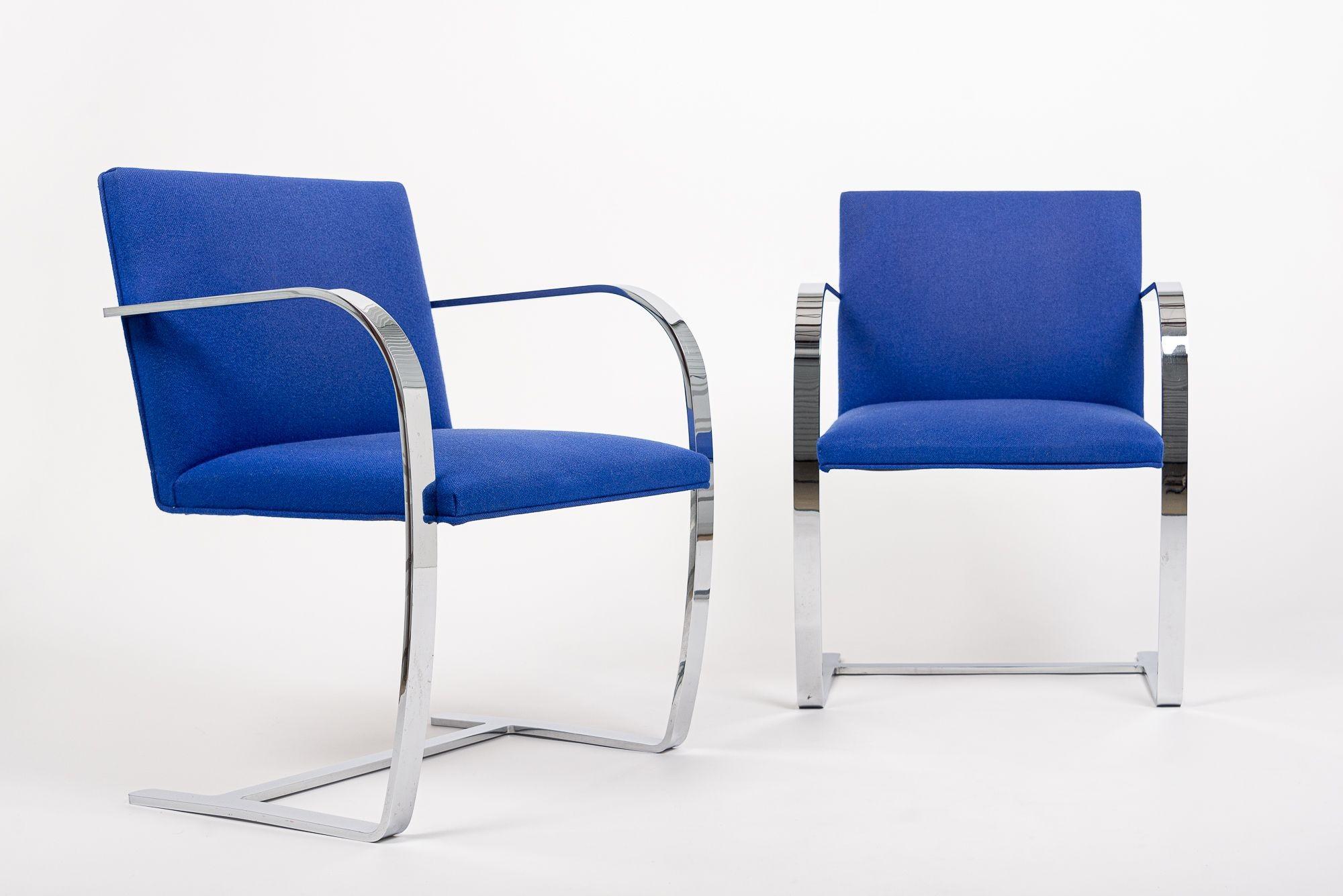 This pair of mid century modern Brno arm chairs by Mies van der Rohe were manufactured by Knoll in 2006. These iconic Bauhaus chairs were designed by Ludwig Mies van der Rohe in 1930 for the Tugendhat residence in Brno, Czechoslovakia. With clean,