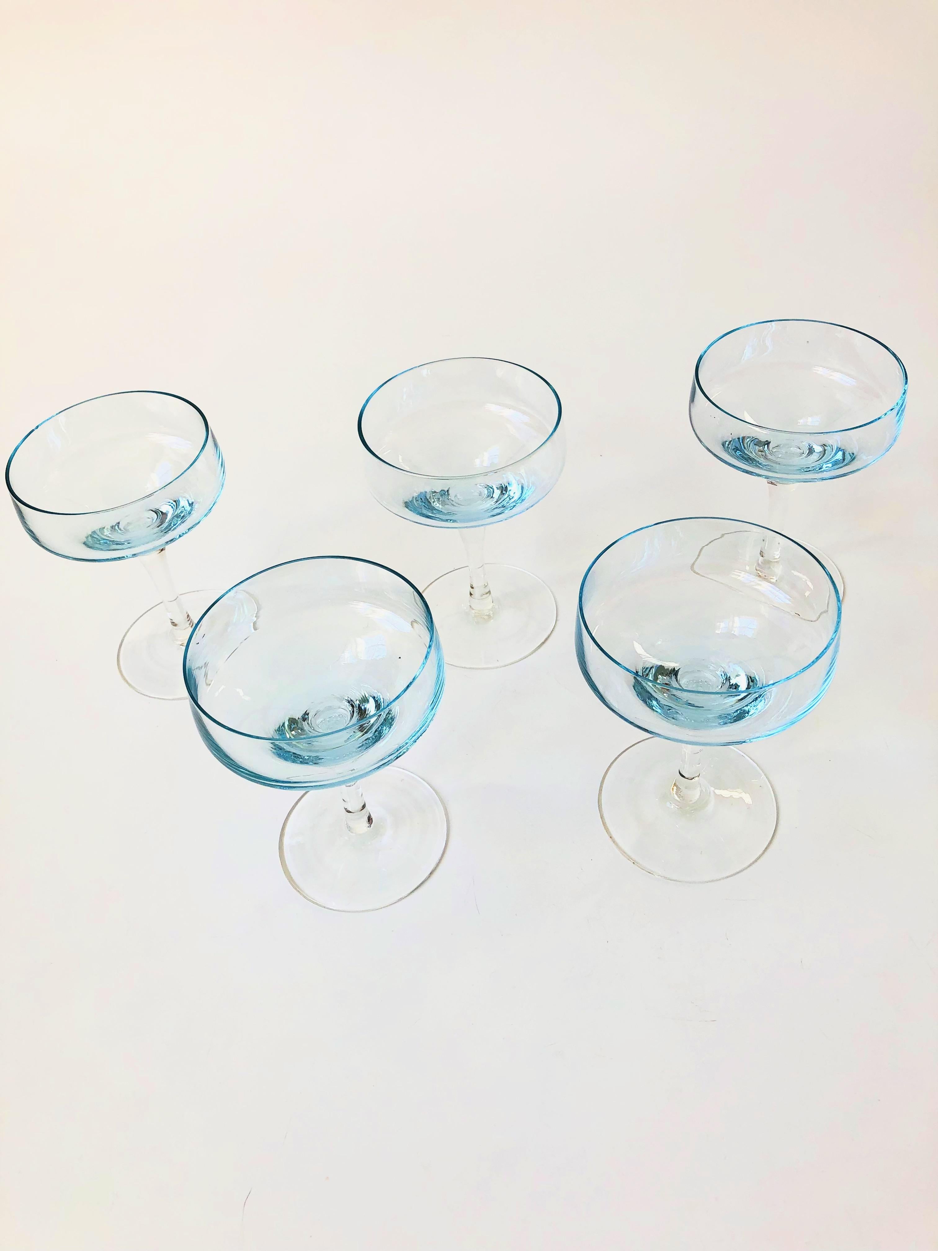A set of 5 vintage coupe cocktail glasses in an elegant mid century shape. Each piece has been made with a light blue top and clear stem. Perfect for champagne.
 