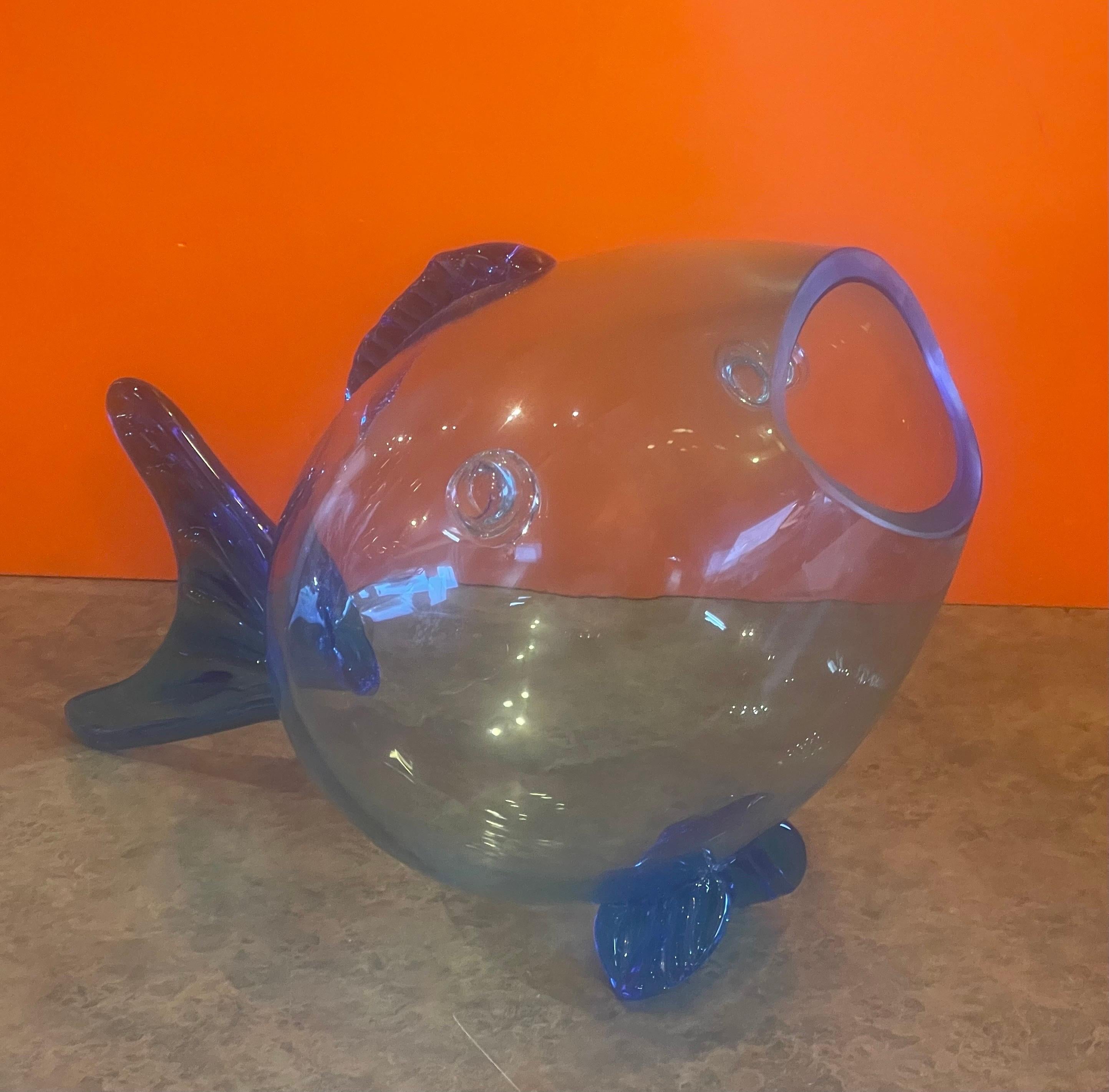 Fun mid-century blue glass fish vase in the style of Blenko Glass, circa 1970s. The vase is in very good vintage condition with no chips or cracks and measures 15.75