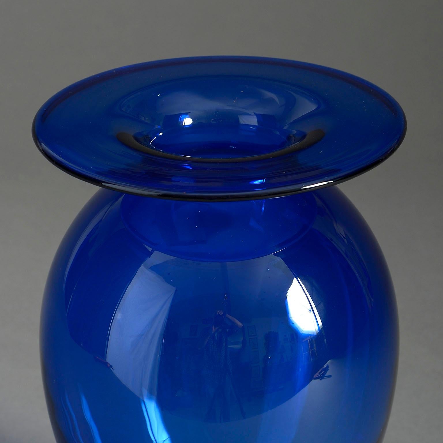 A mid-century deep blue glass vase with generous rim and bulbous body.