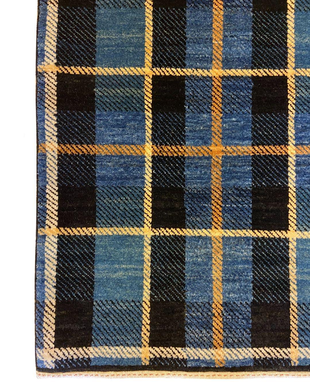 This mid-century blue, red, yellow, and black plaid tartan wool Persian rug, sized 4' x 5', takes its inspiration from the official Wisconsin tartan, a symbol of the state’s rich history and culture. The design features colors that represent