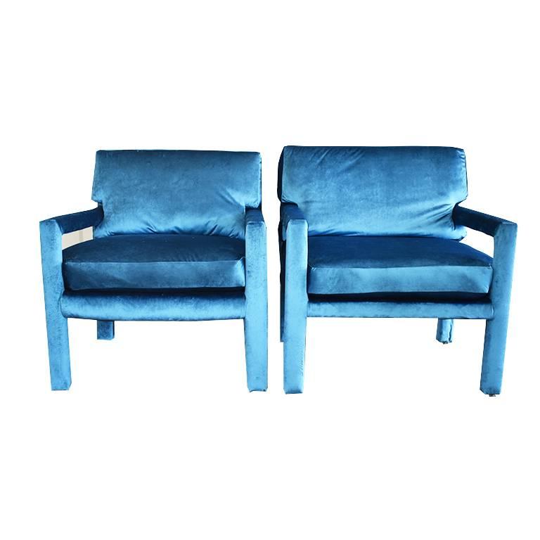 Pair of midcentury blue velvet Milo Baughman style armchairs. Newly upholstered in a buttery soft blue velvet fabric. (Jewel tones are all the rage in 2018) The back cushions on the chair are cut into accommodate the side arms, and are removable.