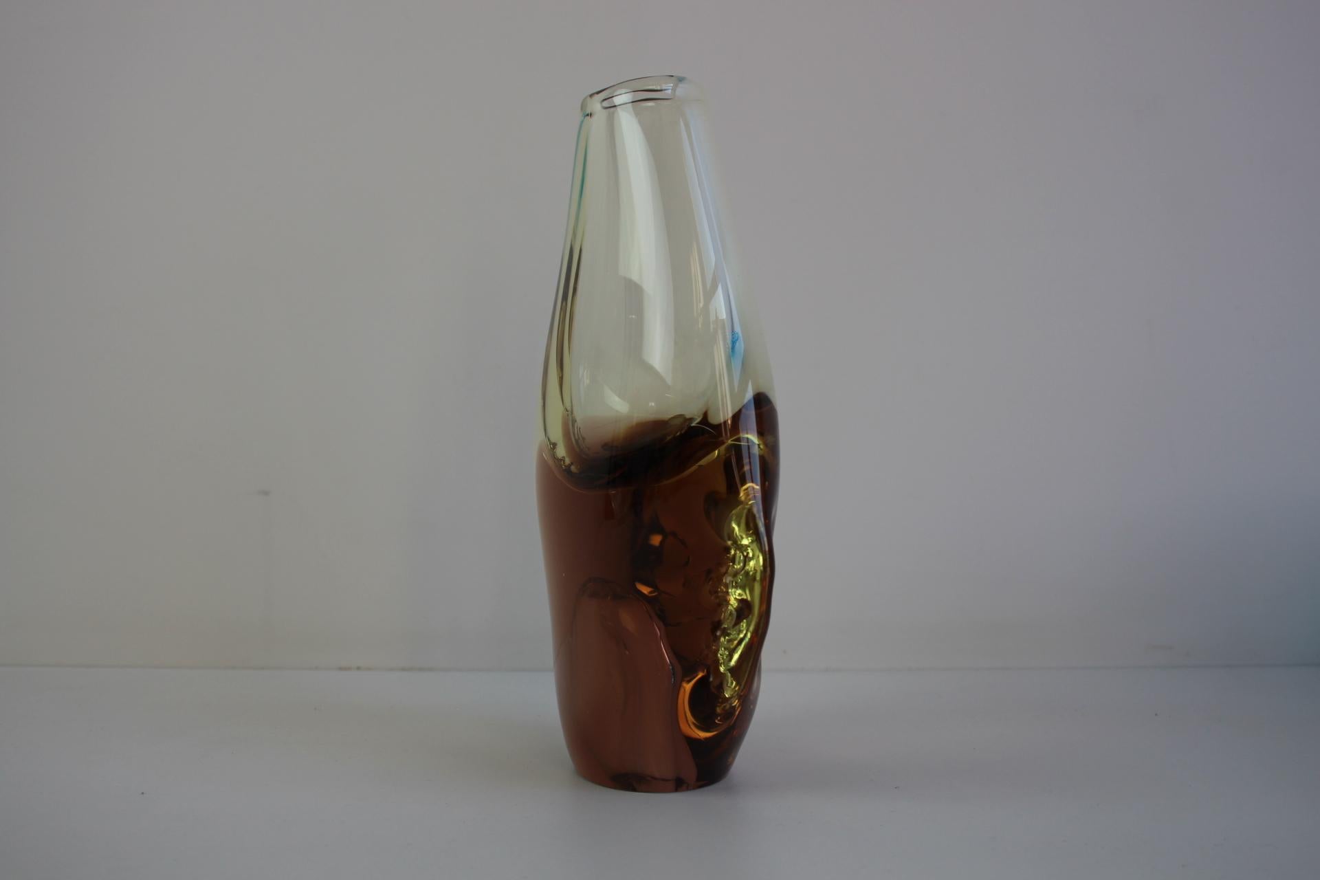 Elegant mid-century Bohemian art glass vase in warm amber tones, handblown in Czechoslovakia in the 1960s and marked Bohemian Glass. Attributed to Zeleznobrodske Sklo (ZBS), this piece features a classic teardrop form with a thick clear casing and