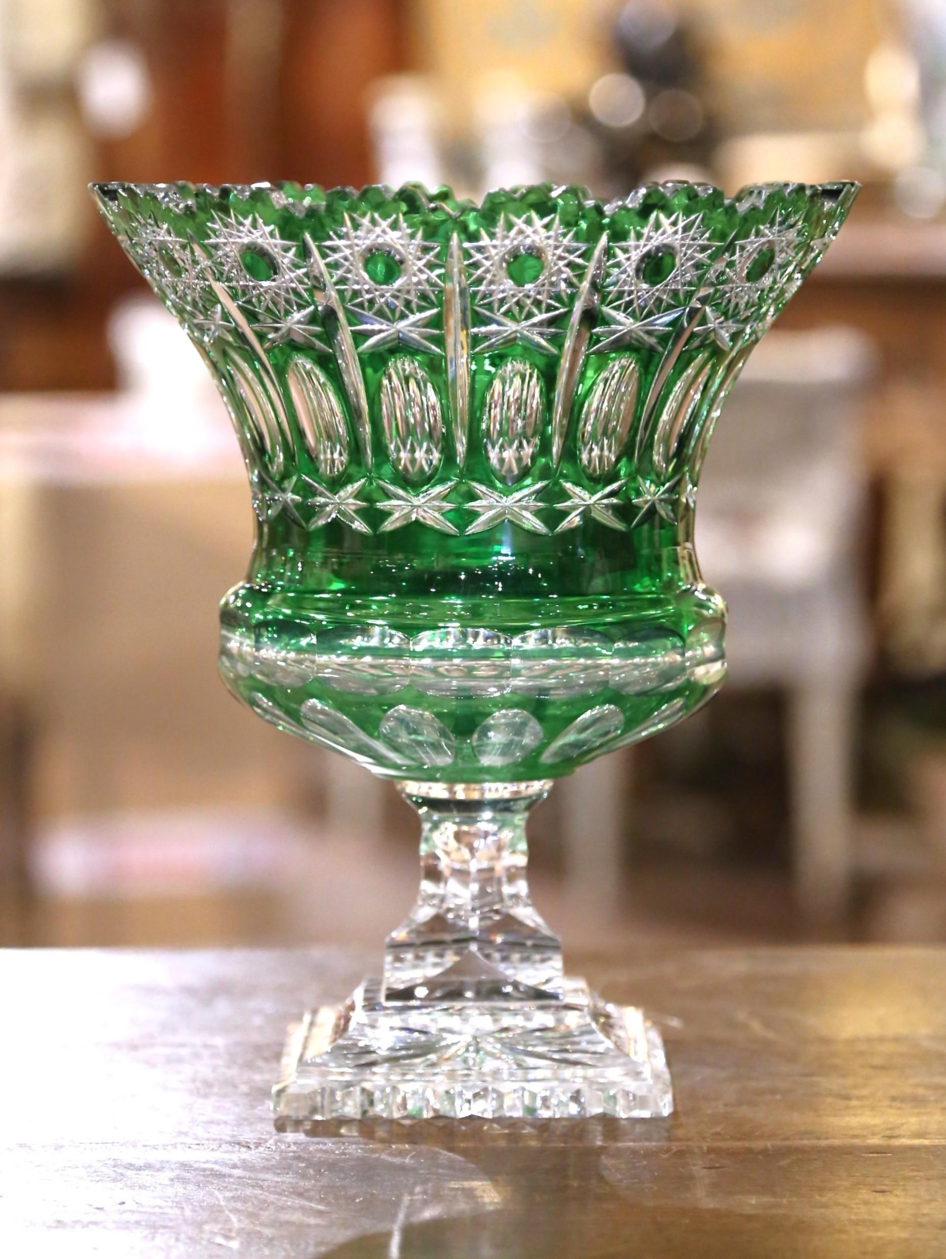 Vibrant and finely detailed, this mid-century Bohemian cut-to-clear crystal compote showcases the exceptional artistry of Czech glassmakers. The striking emerald green overlay is expertly cut through to clear crystal in an ornate pattern of