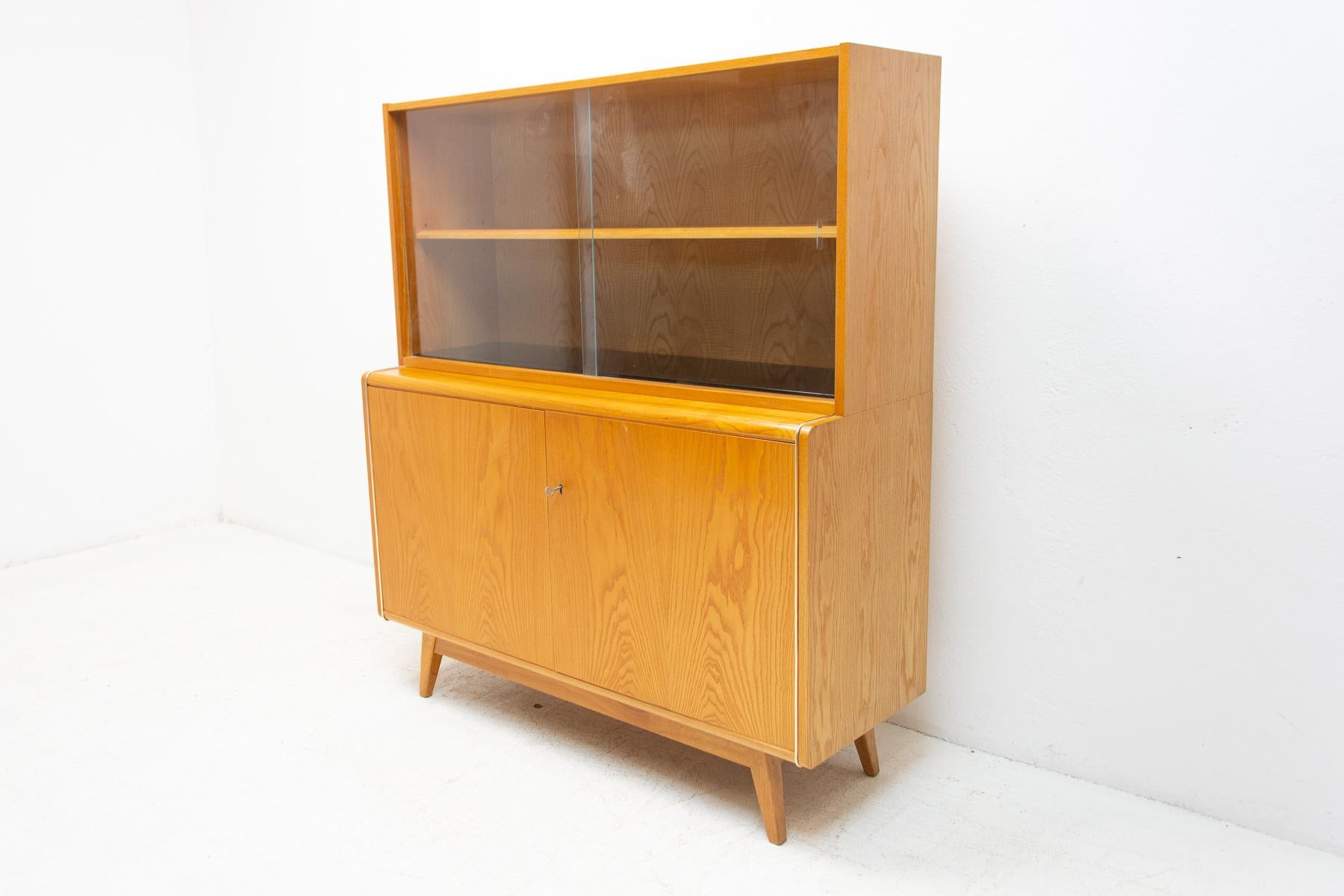 Mid century Vintage bookcase from the 1960s. It was designed by Hubert Nepožitek & Bohumil Landsman for Jitona in the former Czechoslovakia. Features a simple design, a glazed section with a storage spaces. In very good Vintage condition, showing