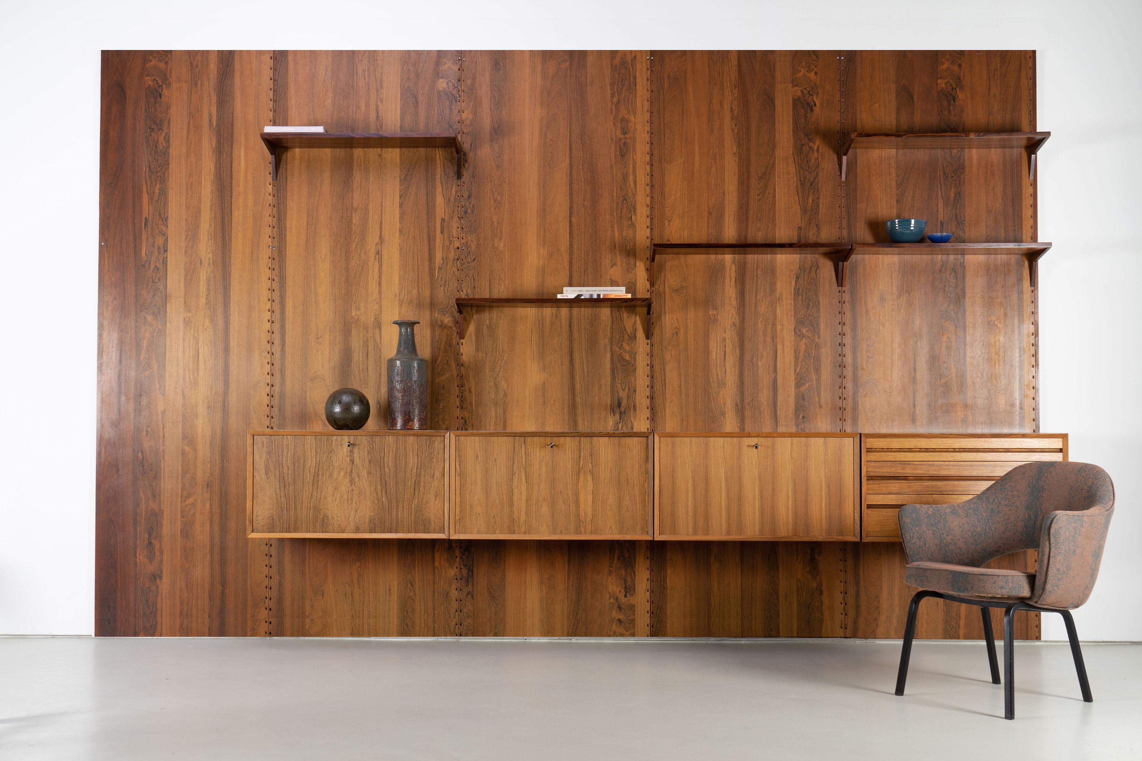 Stunning rosewood wall unit from the 1960s by danish Designer Poul Cadovius. The unit features five wall panels, four sideboard elements and 11 shelves (more than shown in the pictures.) This piece comes with CITES Documents.
