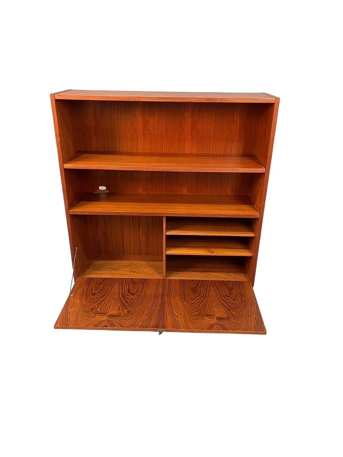 Mid Century teak danish bouquets with Storage in the bottom 1960s Circa the shelf are adjustable and removable. 
Dimensions W39 1/2 x D11 1/2 x H47 inches