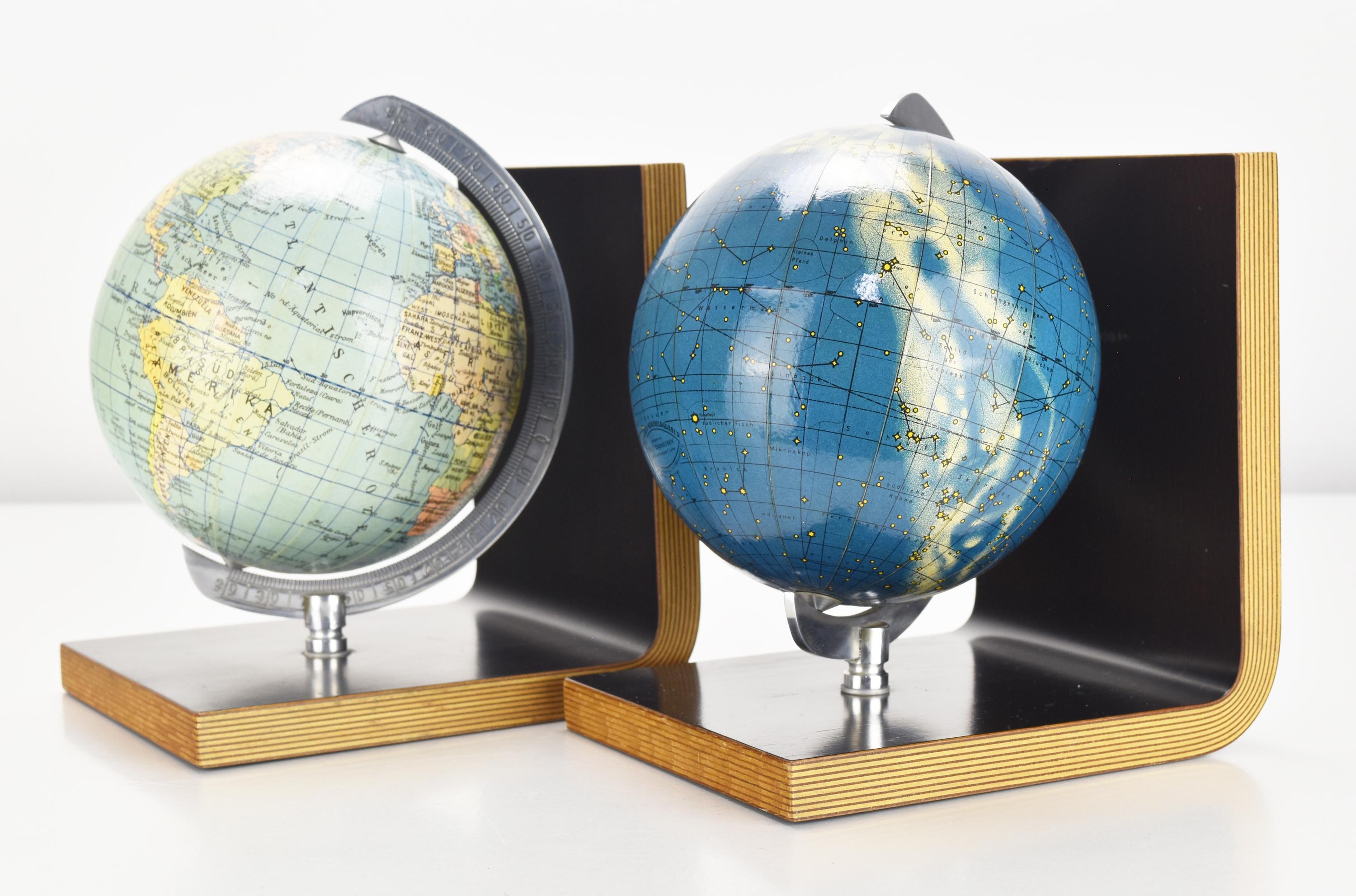 A pair of vintage German decorative bookends with spinning globes of the moon and earth
