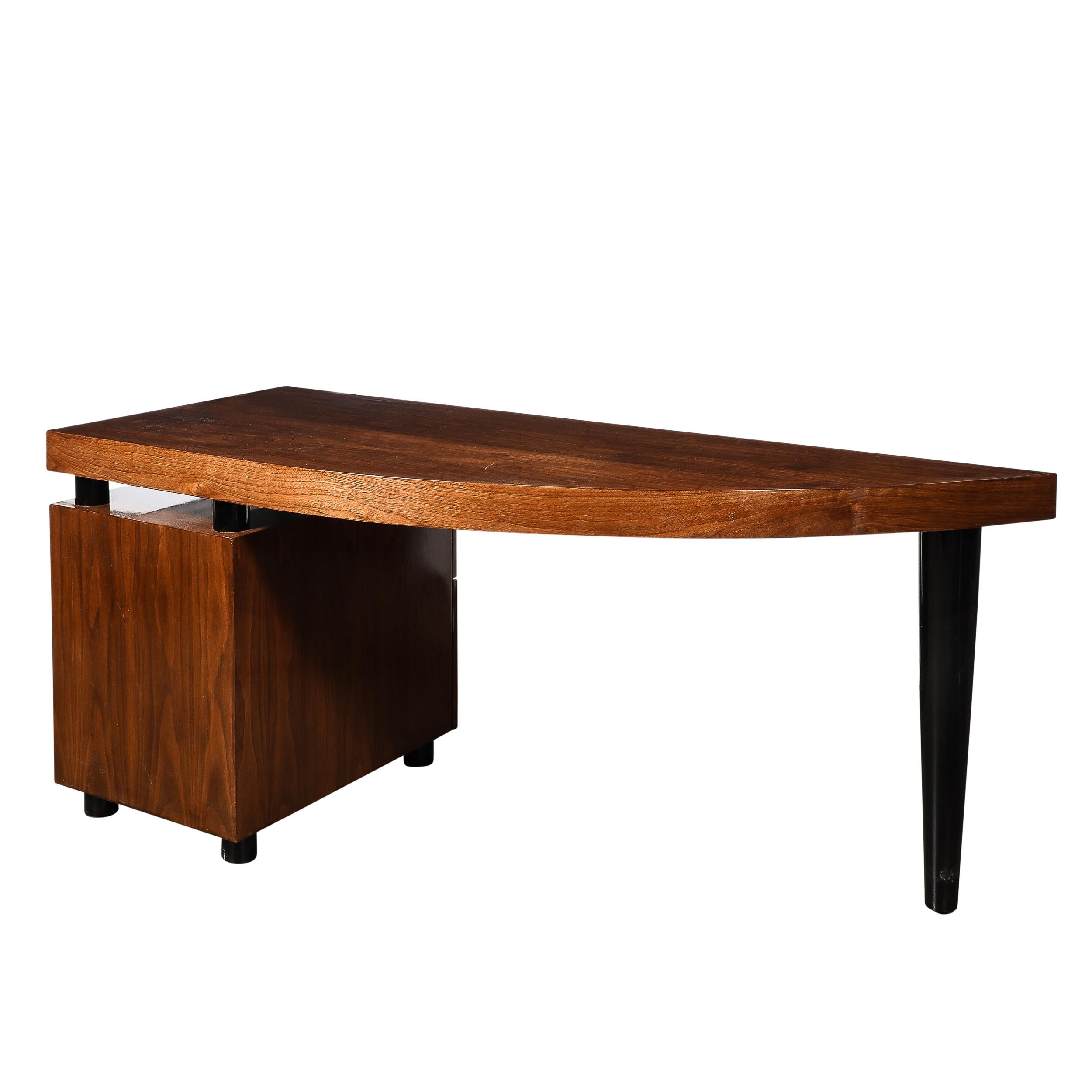 This unique and brilliantly proportioned Mid-Century Modernist Boca Desk in Bookmatched Walnut W/ Tapered Black Lacquer Support is by Leon Rosen for Pace and originates from the United States Circa 1980. Formed in a lovely hue of bookmatched walnut