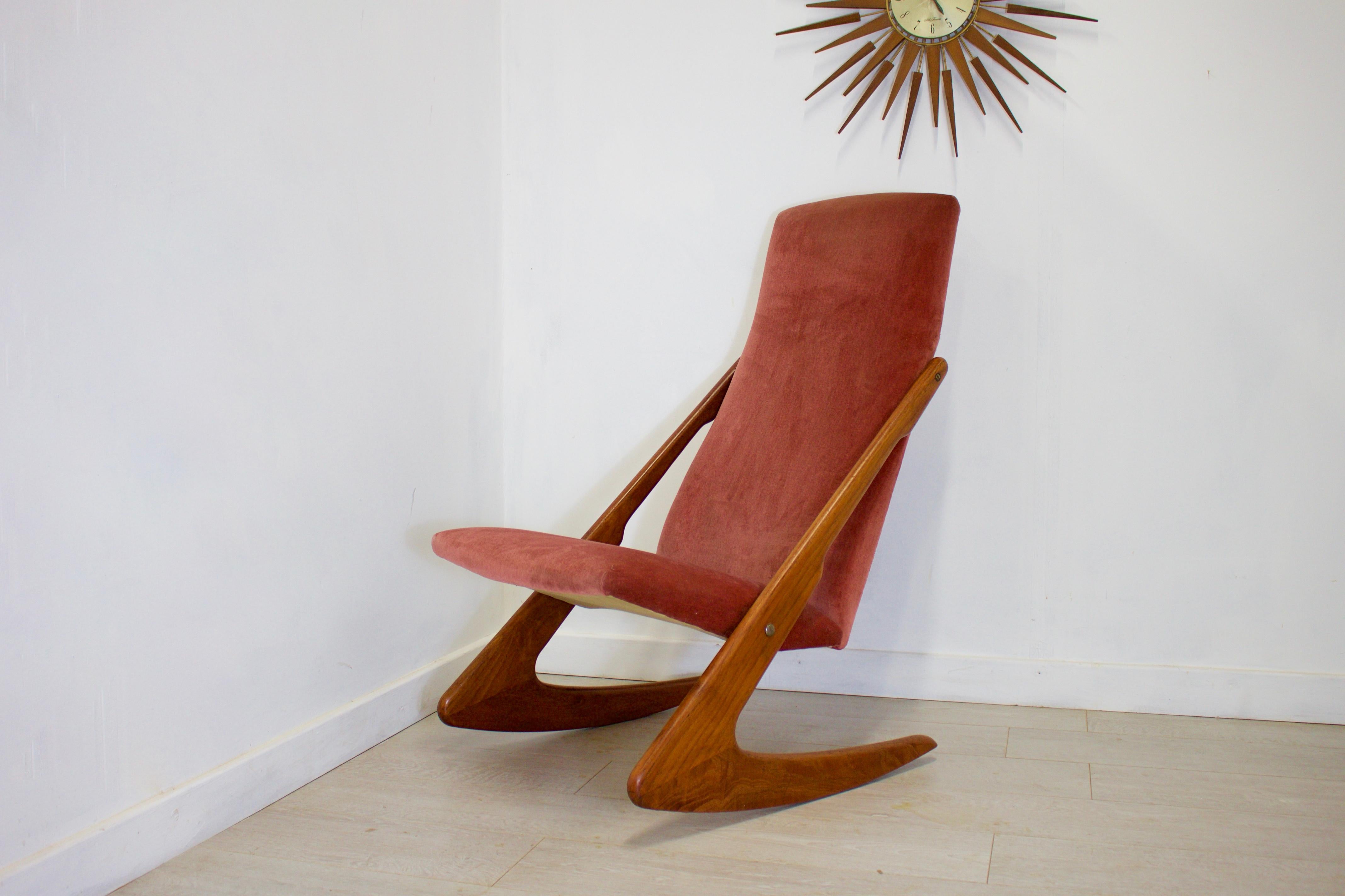 - Mid-Century Modern armchair
- Made in Denmark by Mogens Kold
- Made from teak and velour.