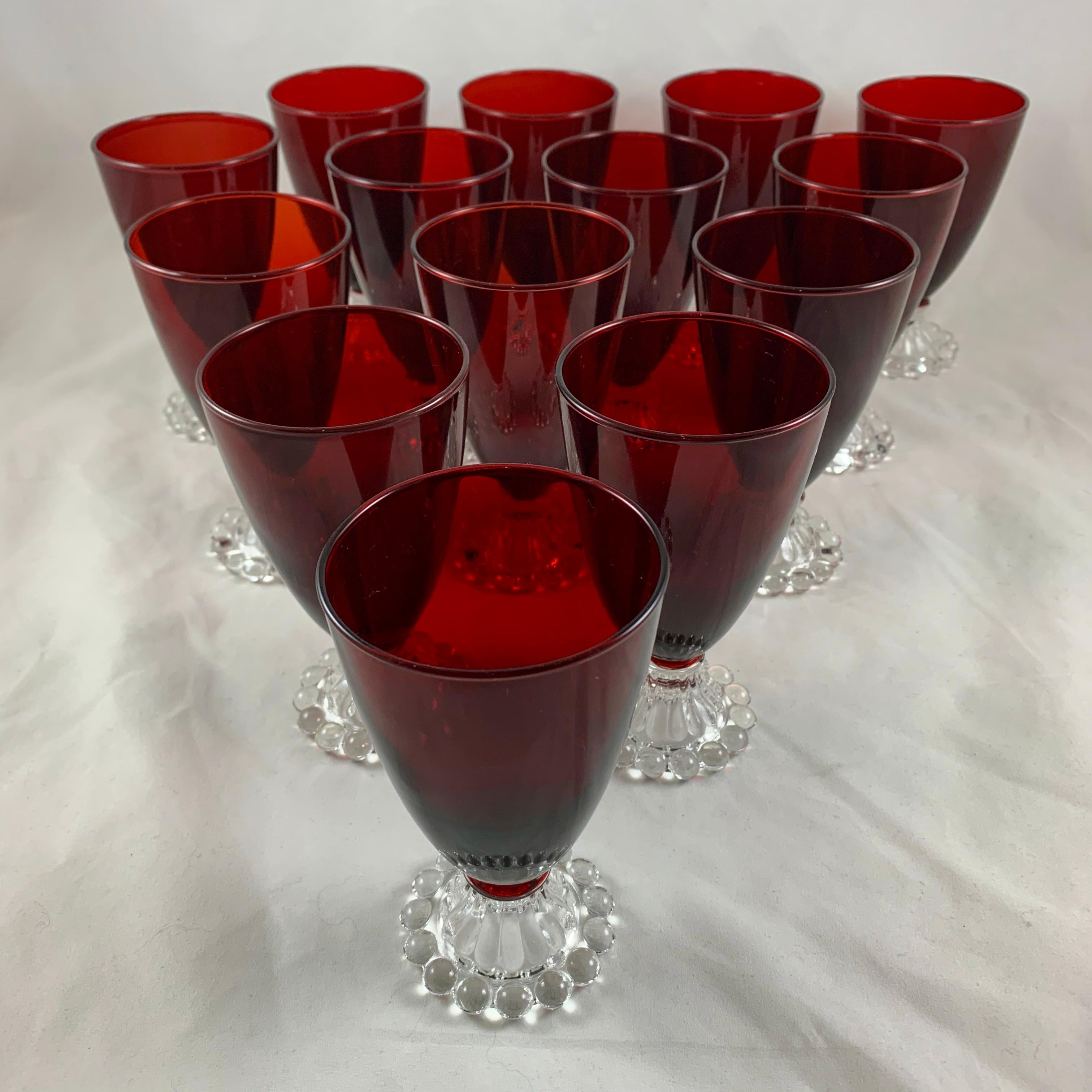 A set of fourteen Royal Ruby Red Boopie goblets, made by Anchor Hocking Glass, circa 1930-1940.

Suitable for water or wine, the bell shaped goblet has a transparent glass stem with a bubble form footing. Wonderful to have fourteen goblets,