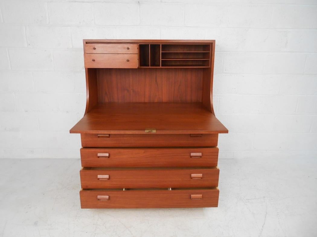 This stunning vintage modern upright desk features a drop front and four hefty drawers. A sleek design that provides plenty of workspace and room for storage. Quality construction by Børge Mogensen with sculpted pulls, dovetailed drawers, and a rich