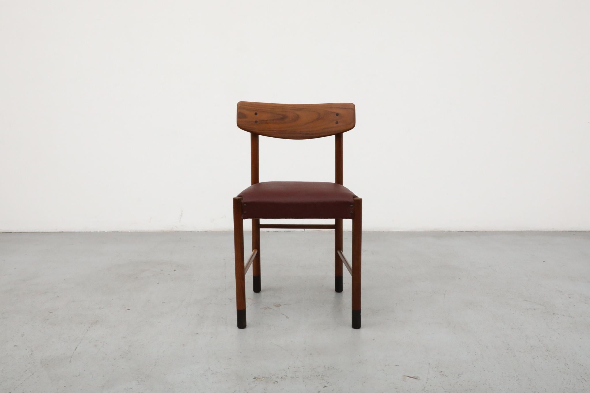 Mid-Century teak dining chair with attractively curved backrest and comfortable burgundy skai leather upholstered seat. Handsomely made in the style of Danish designer Børge Mogensen. It is in original condition with some light wear and scuffs on
