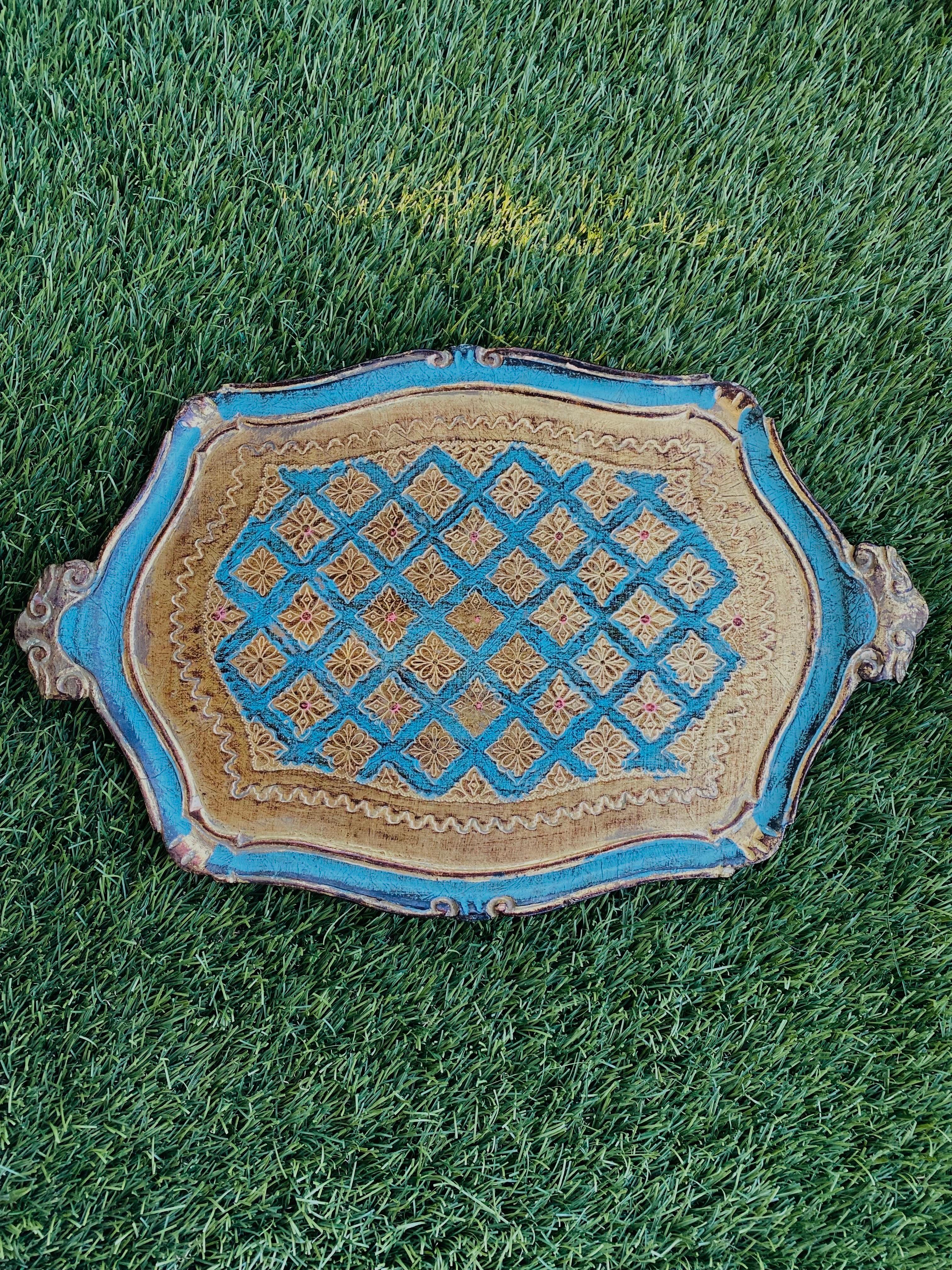 Beautiful Mid Century wood tray with incredible artistic design detail.  This beautiful piece shines in shades of gilt and turquoise.  With hand applied detail all around, this piece adds auras of regal taste in minimalist or maximalist spaces. 