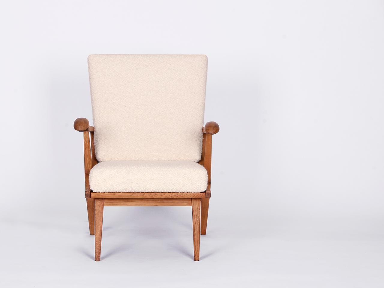 Mid century Boucle armchair from the 1960s, manufactured in former Czechoslovakia. Newly varnished wooden parts, solid coconut fiber upholstery. Fully restored. With a wonderfully soft english cover boucle fabric made of wool. This completely