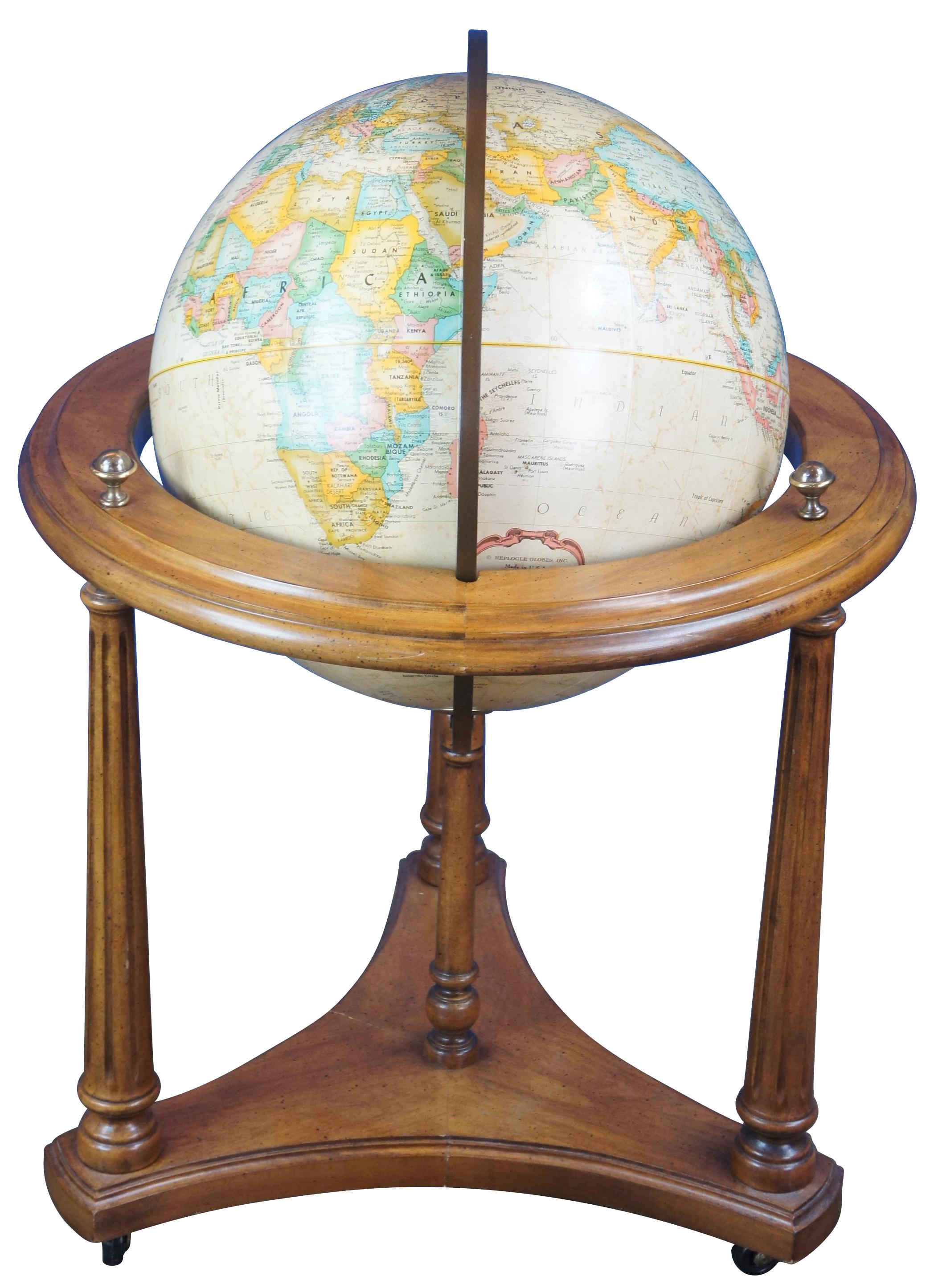Mid Century Brandt Replogle world globe. Made of cherry featuring turned fluted column supports with triangular base and castors with Replogle 16