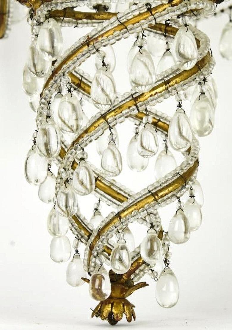 Midcentury brass and beaded crystal 8-light chandelier attributed to Baguès.