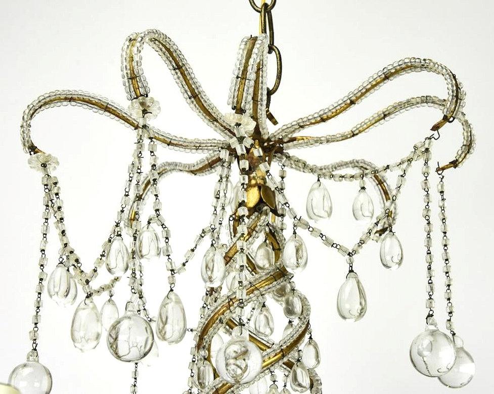 Midcentury Brass and Beaded Crystal 8-Light Chandelier Attributed to Baguès In Good Condition For Sale In New York, NY