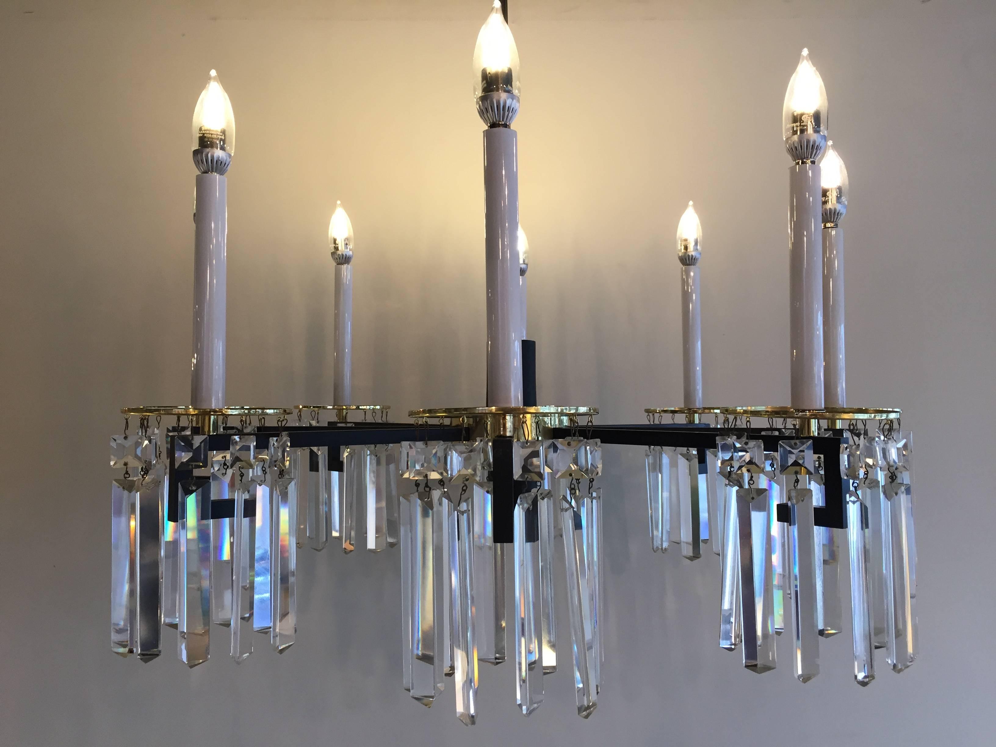Parzinger style midcentury brass and black Greek key design eight-arm drop long faceted crystal chandelier.