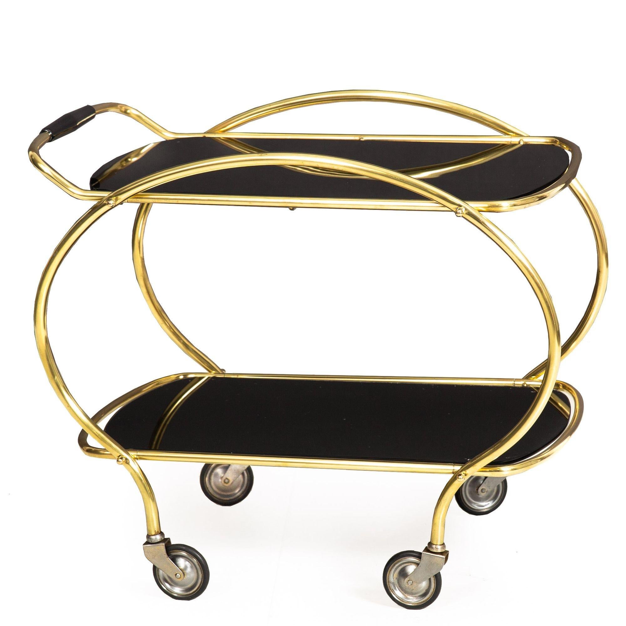 MID-CENTURY BRASS AND BLACK GLASS TWO-TIER SERVING CART
Probably United States, circa 1950s
Item # 311WGP02K

A super fun curvy two-tier bar cart from the 1950s, it has a distinctly 