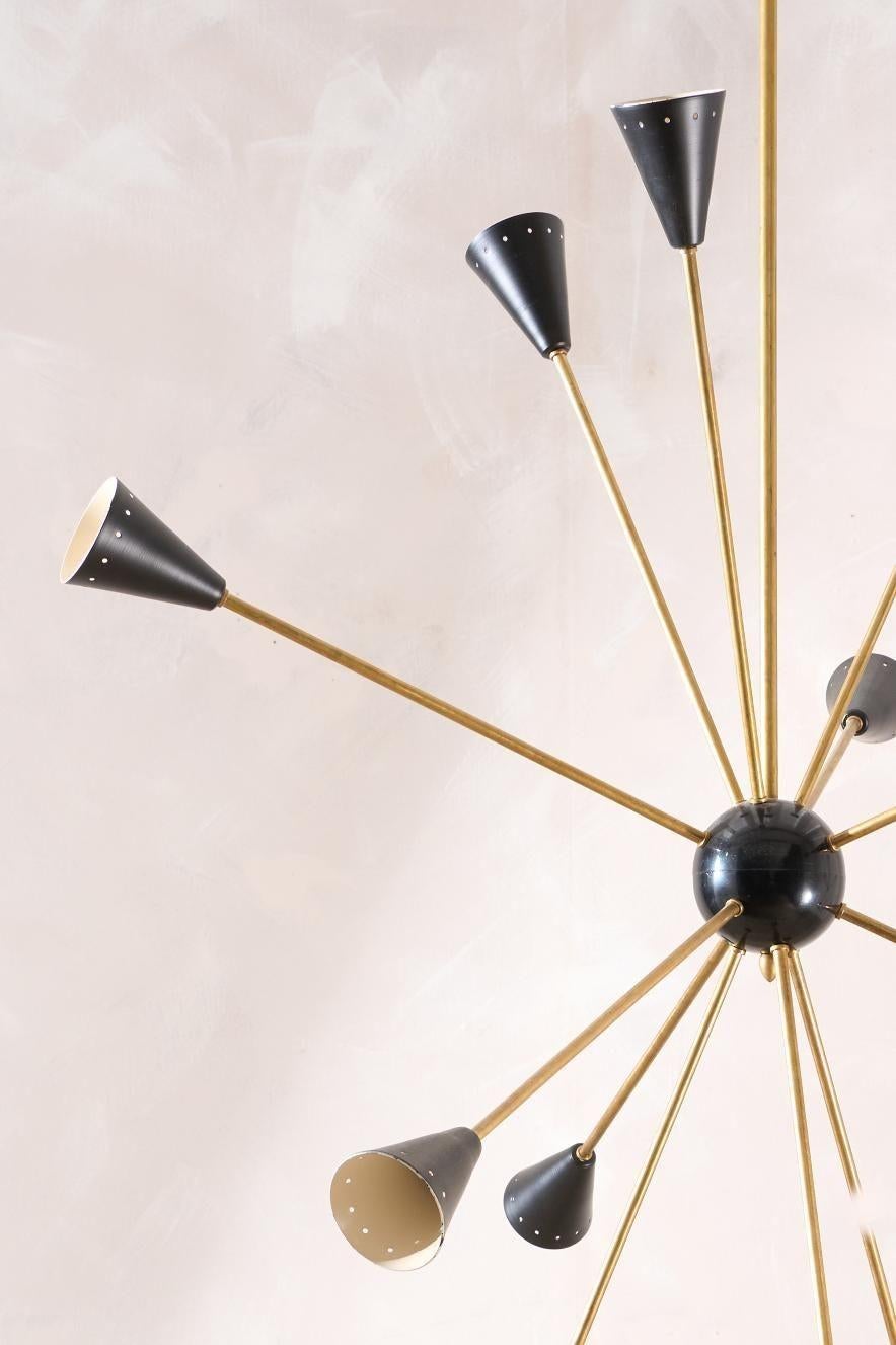 This is a very stylish mid century Italian ceiling light by Stilnovo. Made from brass with a black shade. The overall design is effortlessly stunning with its minimal profile and sleek nature. The multi arm design makes it a real statement in an