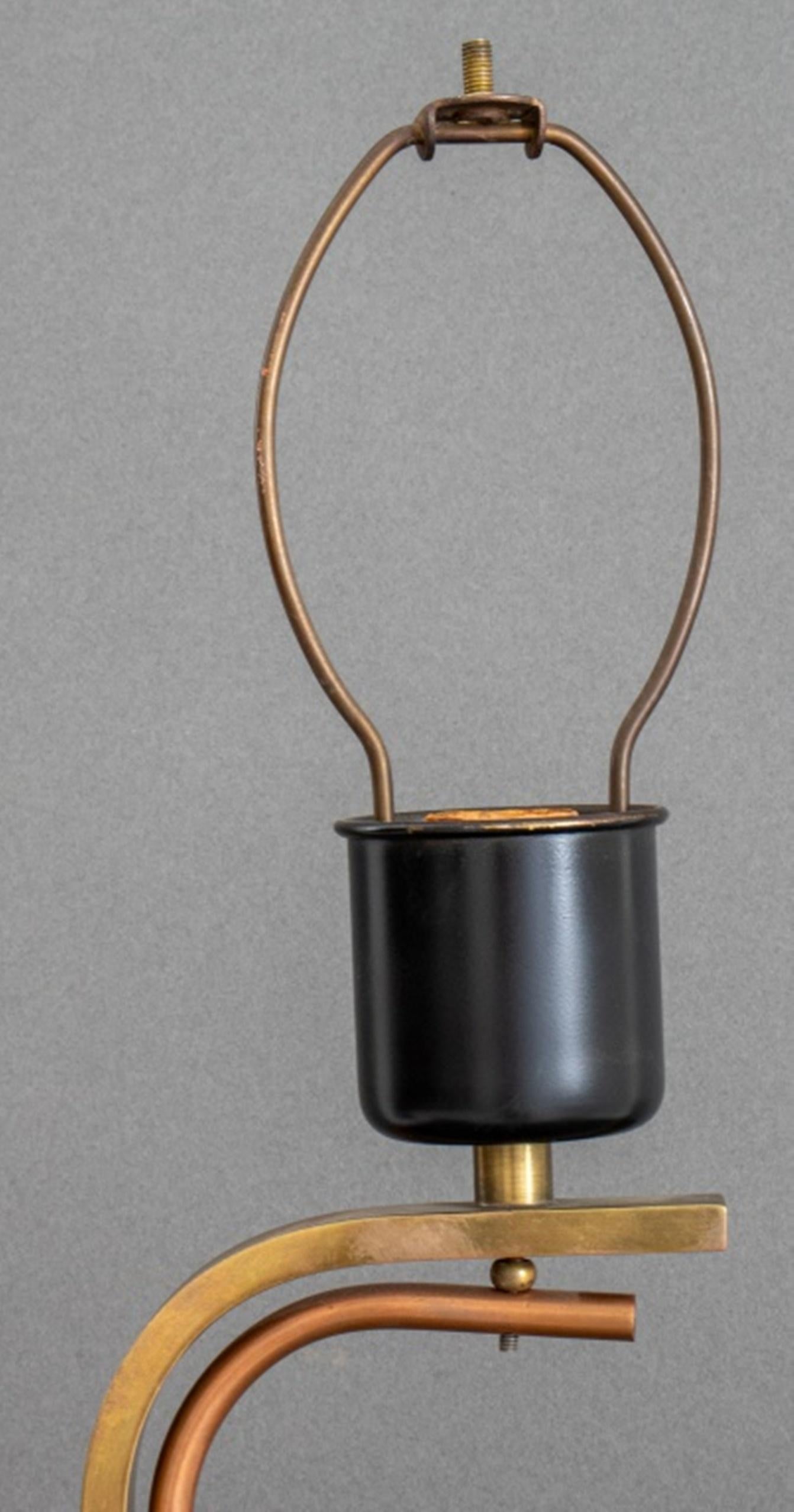 Mid-Century Brass and Copper Scroll Form Lamp on square ebonized plinth.

Dimensions: 30