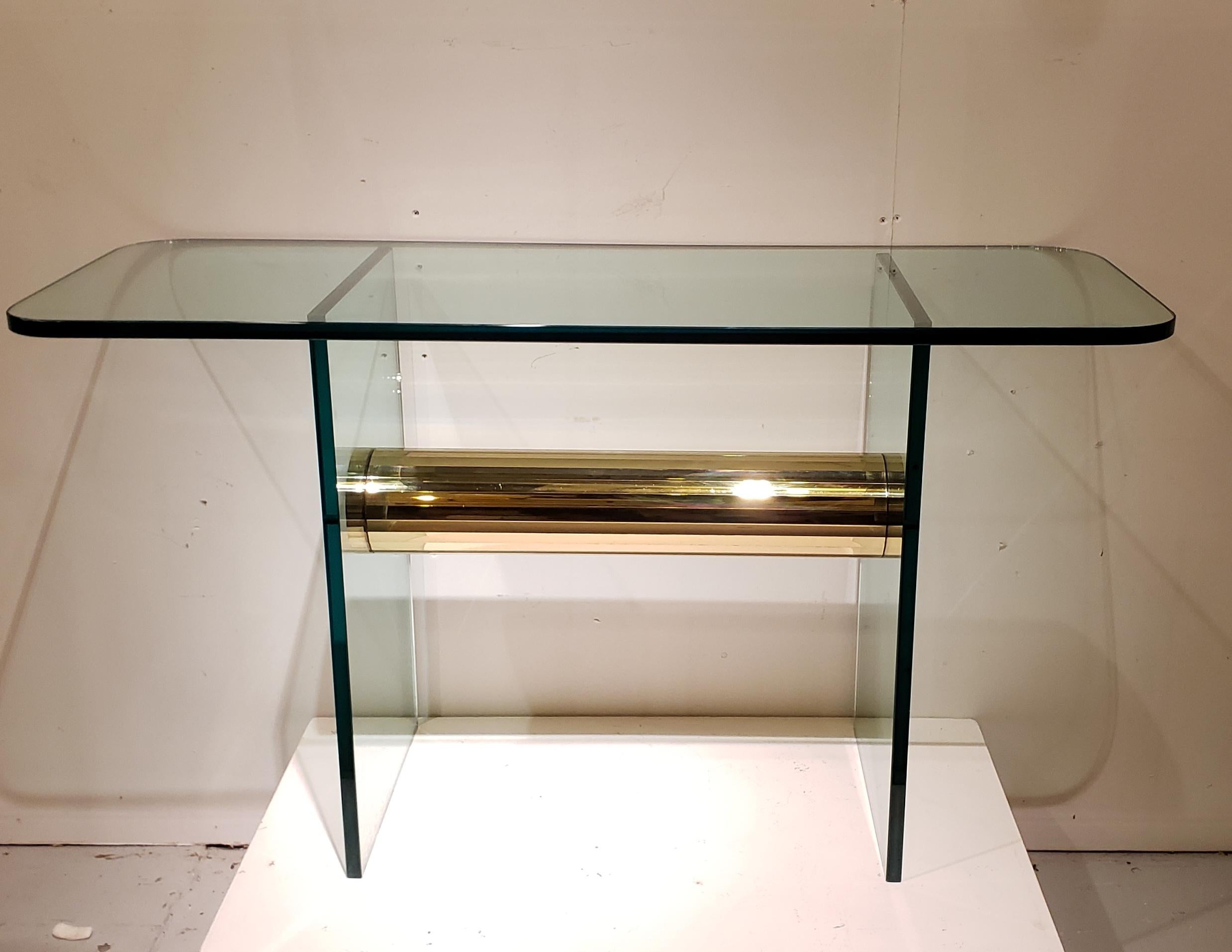 A very chic console made of heavy glass and brass. Easy to disassemble for shipping.
Can also be used as a small desk.

This item is easy to disassemble for shipping purposes
  