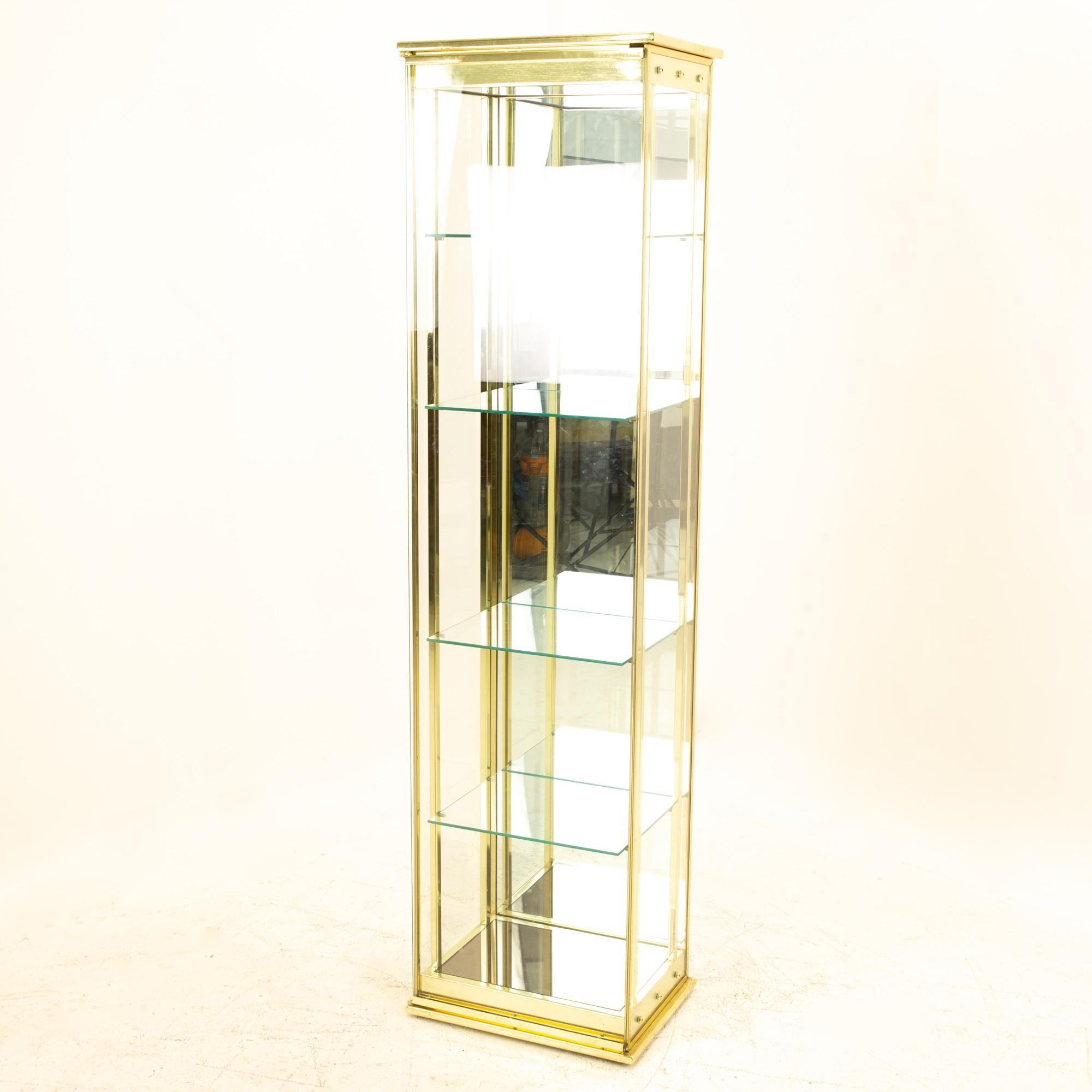 Mid Century brass and glass display cabinet
Cabinet measures: 18.75 wide x 14 deep x 72 high

This piece is available in what we call restored vintage condition. Upon purchase it is thoroughly cleaned and minor repairs are made - all of this is done