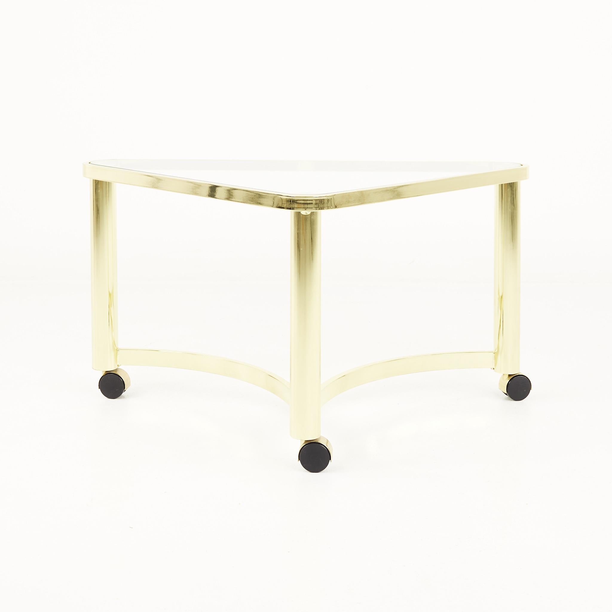 Mid Century brass and glass side table with casters

The table measures: 33.5 wide x 19 deep x 18 inches high

All pieces of furniture can be had in what we call restored vintage condition. That means the piece is restored upon purchase so it’s