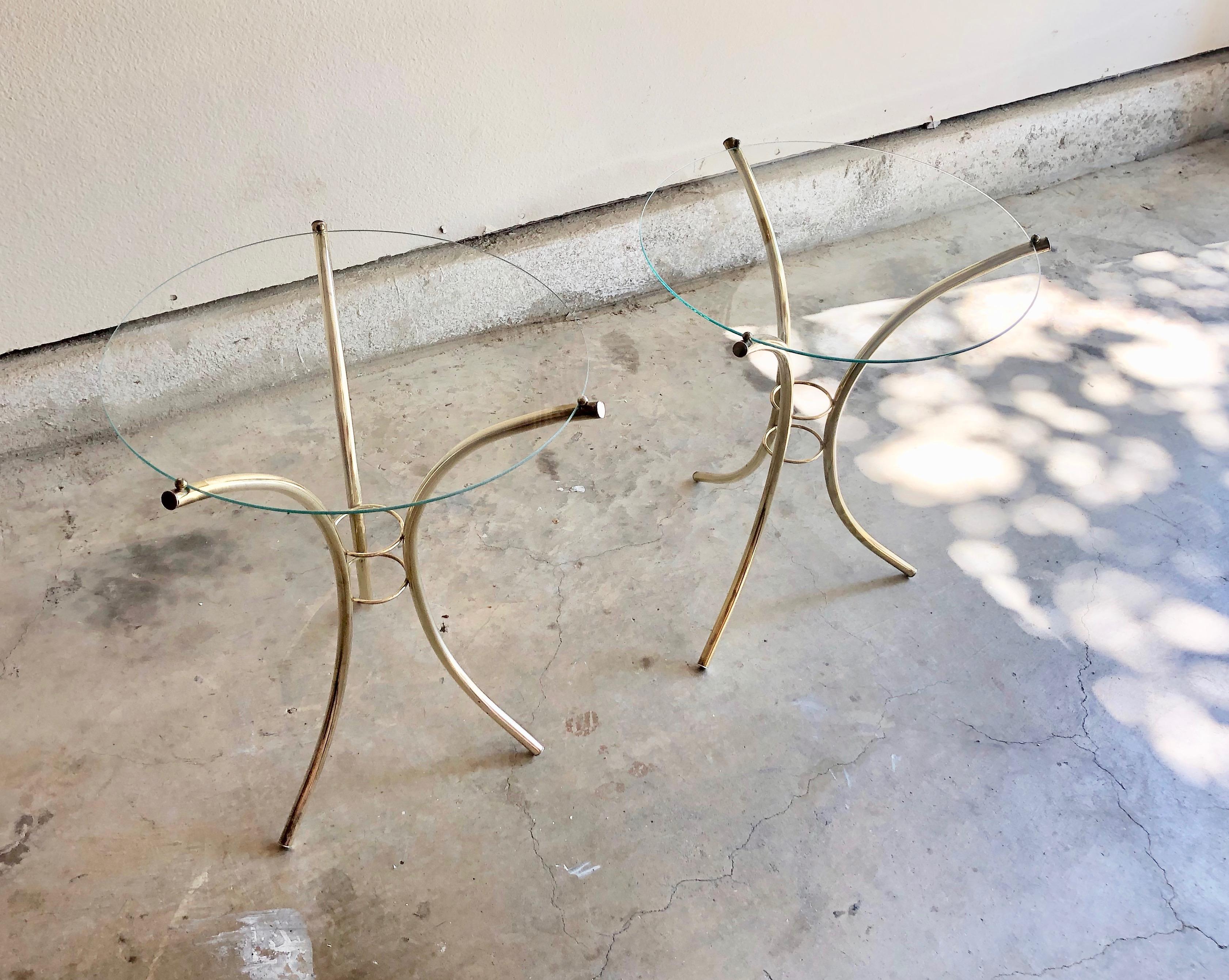 Midcentury brass and glass side tables. Brass-plated steel with a delicate circular glass top.