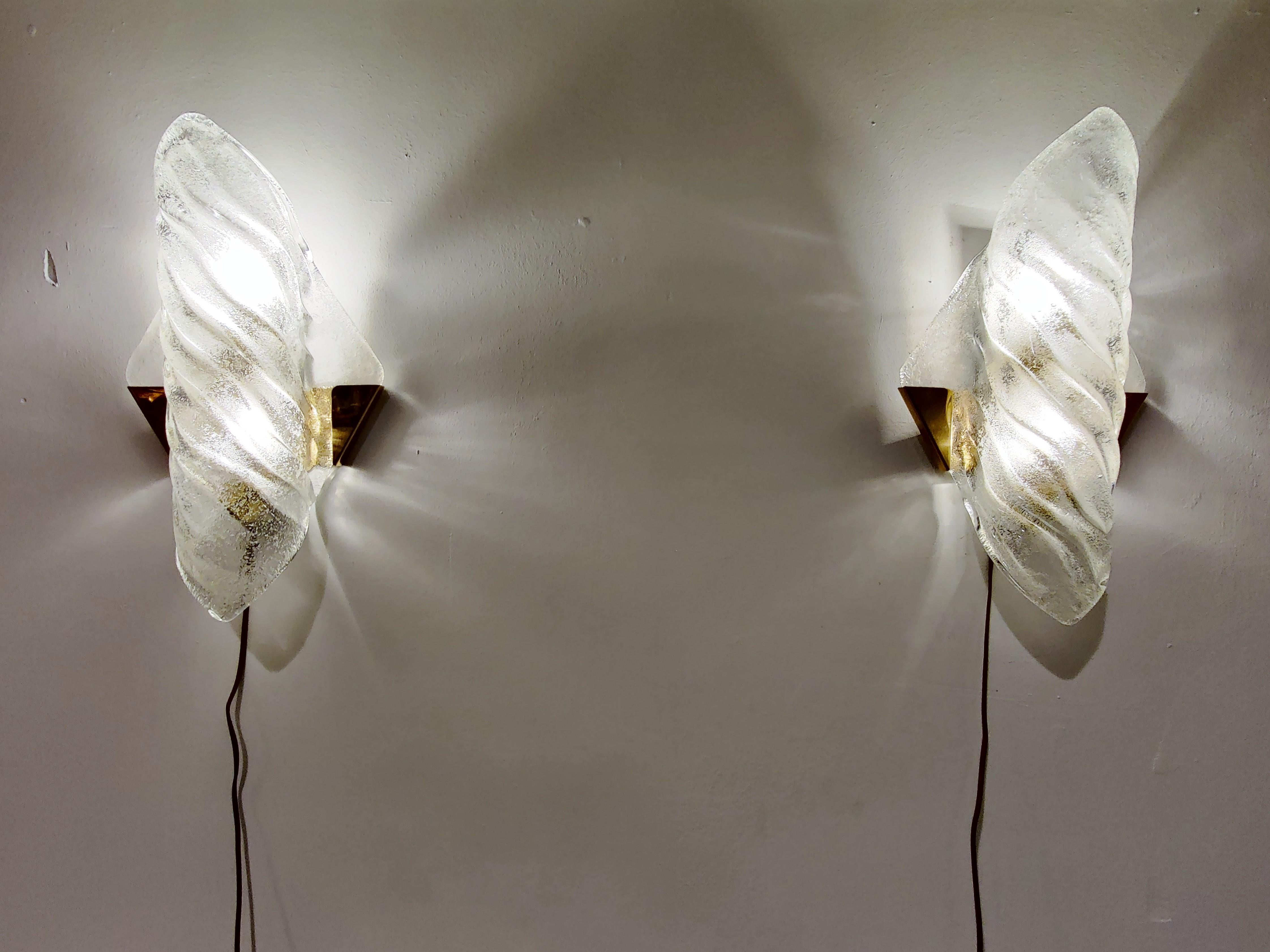 Pair of large midcentury blown glass wall lamps with brass holders.

The lamps emit a beautiful light.

Good condition

Tested and ready to use,

1960s, Germany

Dimensions:
Height: 37cm/14.5
