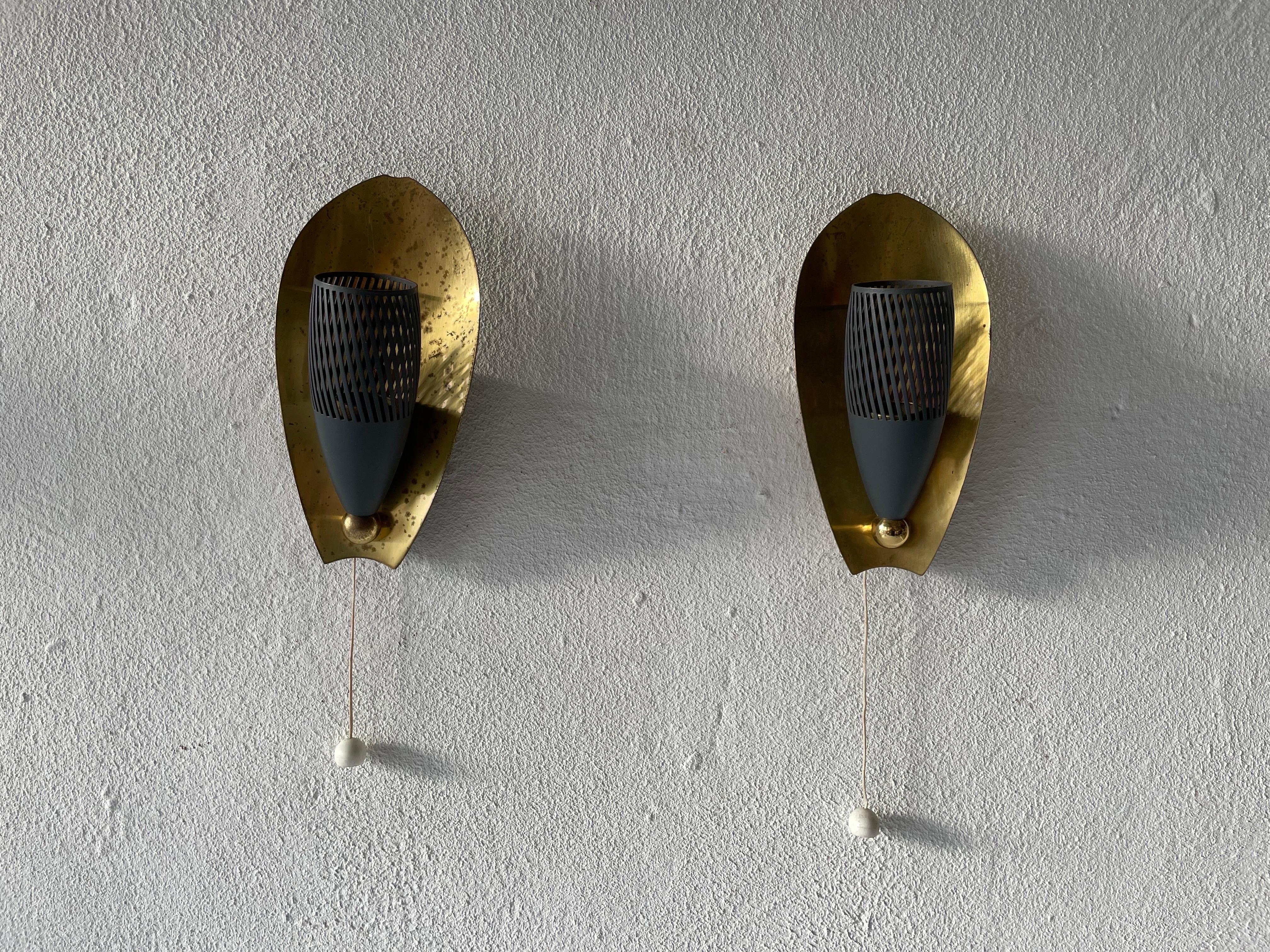 Mid-Century brass and grey metal pair of sconces, 1950s, Germany

Very elegant and Minimalist wall lamps
Lamp is in very good condition.

These lamps works with E14 standard light bulbs. 
Wired and suitable to use in all countries. (110-220