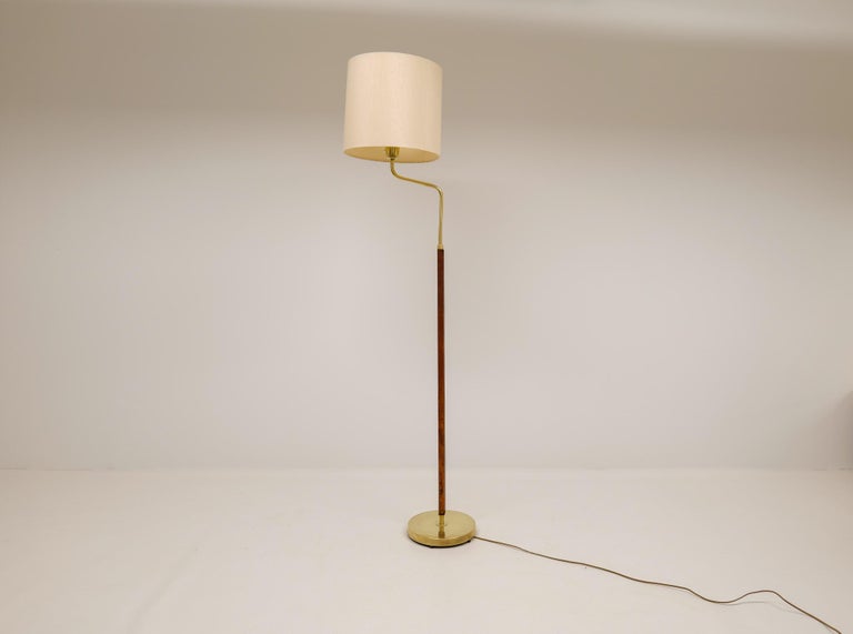This lamp was made in Sweden at Falkenbergs Belysning. Wonderful, assembled brass combination with leather rod. The brass working well together with the brown stitched leather.

Good patinated brass with stains and small dents, working condition.