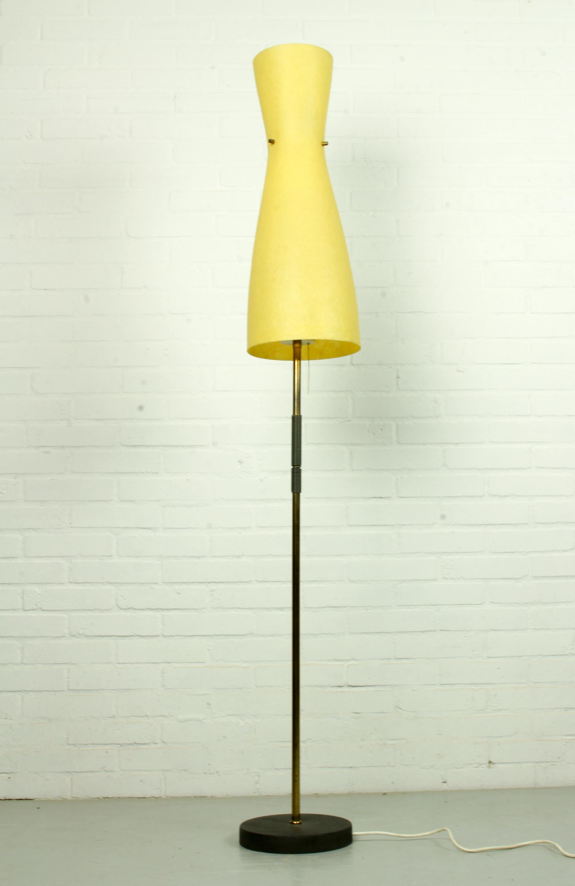 A floor lamp with a fiberglass Diabolo lampshade from circa1950. It features 3 E27 bulbs, switchable in 3 steps: below lights on, top light on or off.