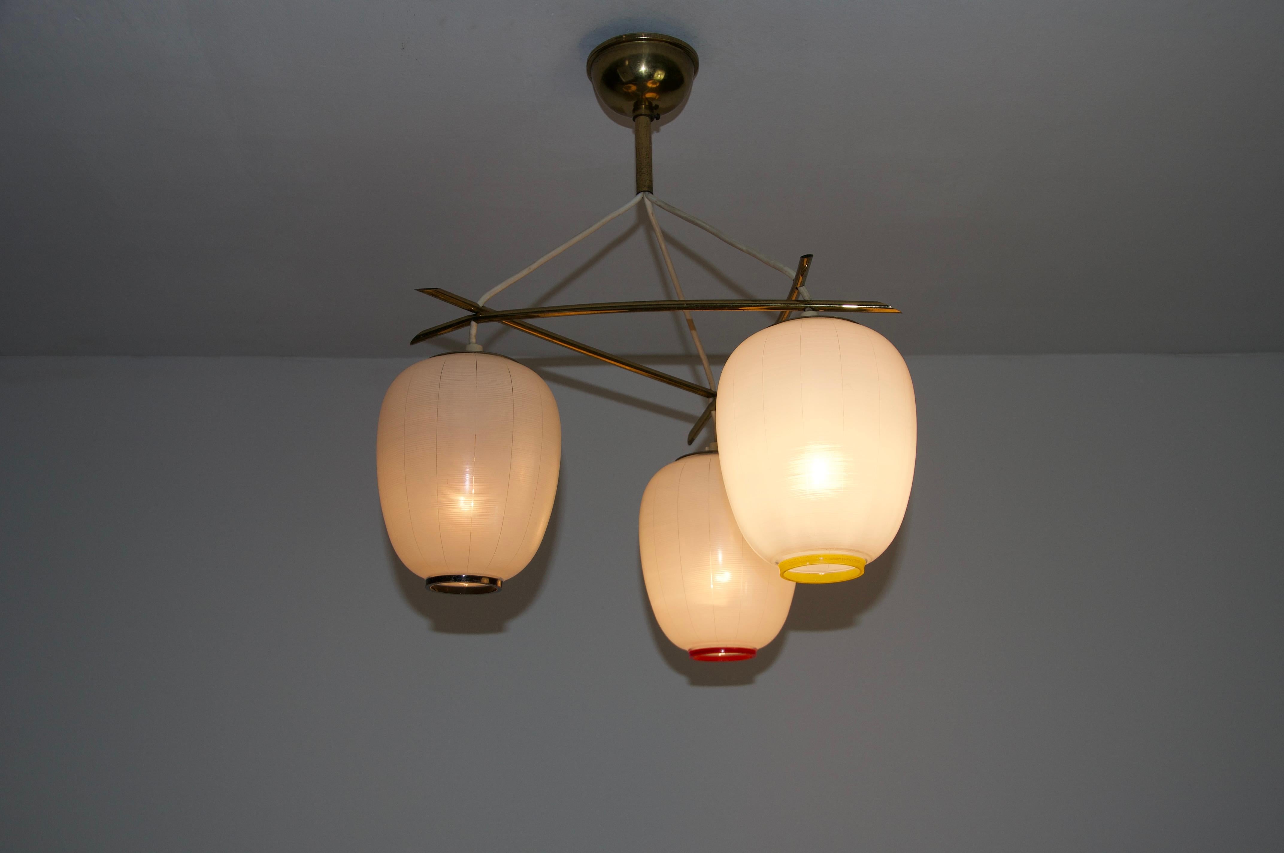 This elegant ceiling lamp from 1960s Germany showcases a refined combination of brass and opal glass. The opal glass diffuser is seamlessly integrated into the brass frame, creating a sophisticated and balanced design.

With its timeless aesthetic