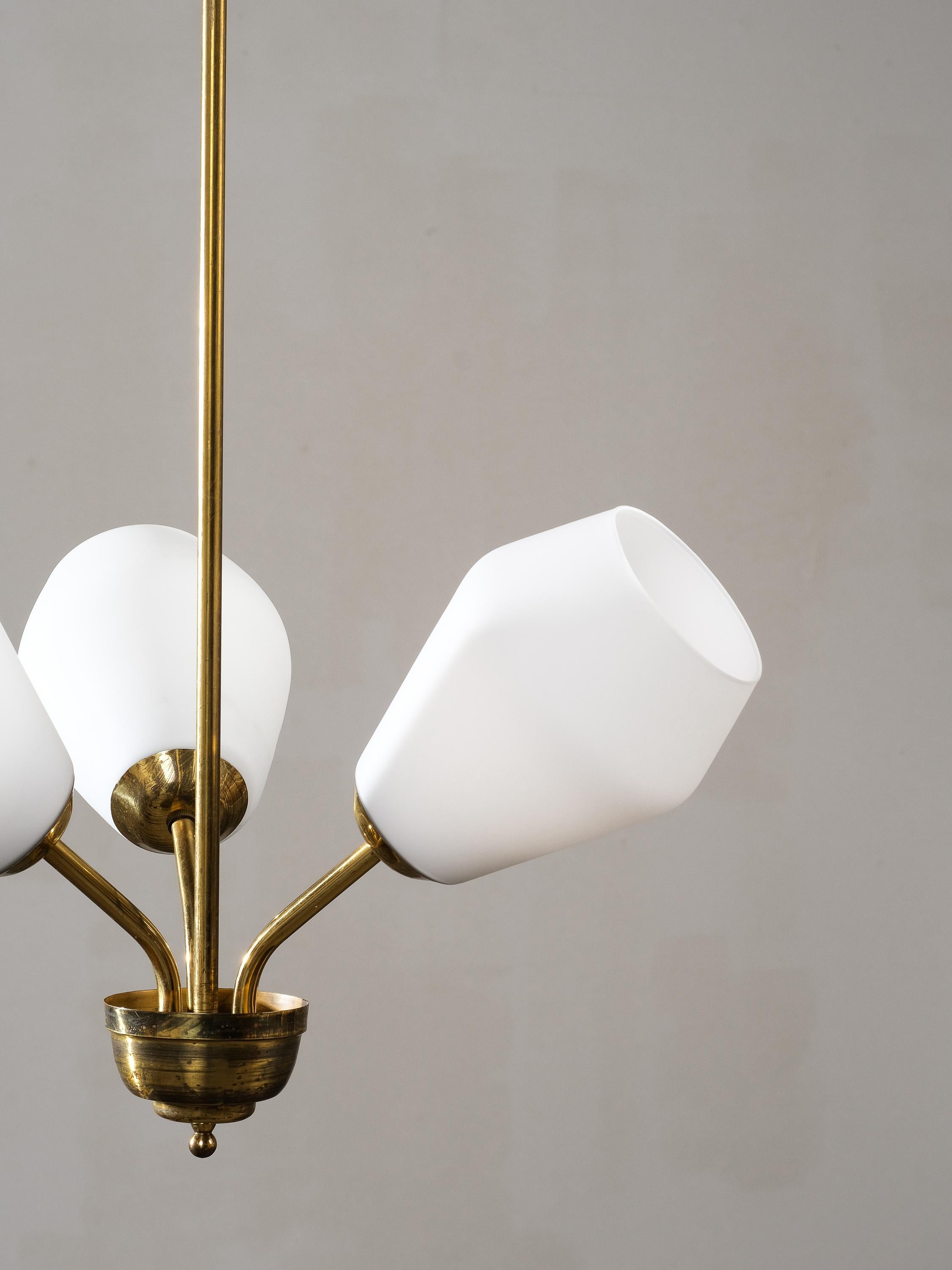 Scandinavian Modern Chandelier, designed and manufactured in Finland, 1950s. Brass frame with opaline glass shades. Good vintage condition, patina and minor wear consistent with age and use.