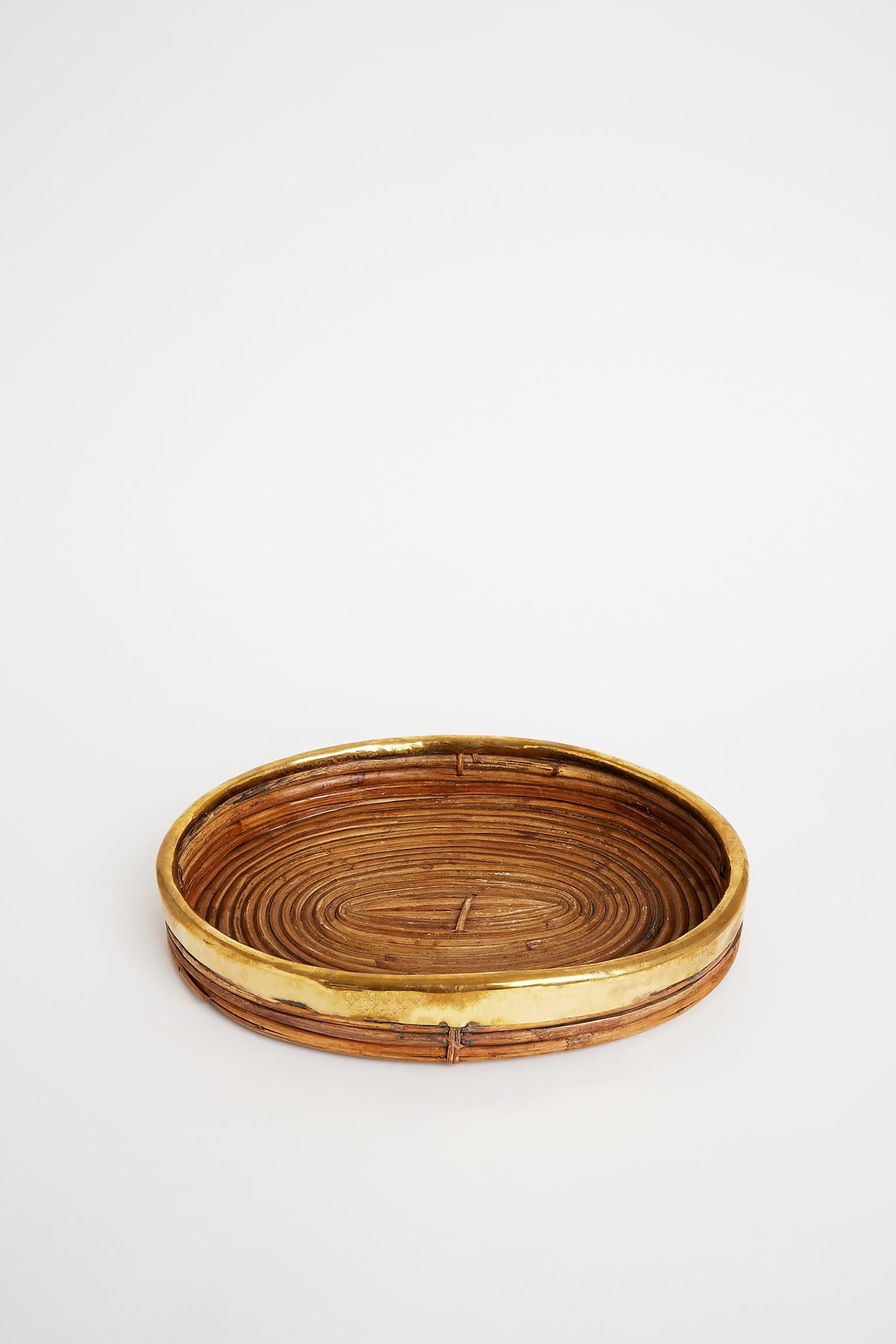 A brass and reed oval tray, in the manner of Gabriella Crespi.
Italy, circa 1970.