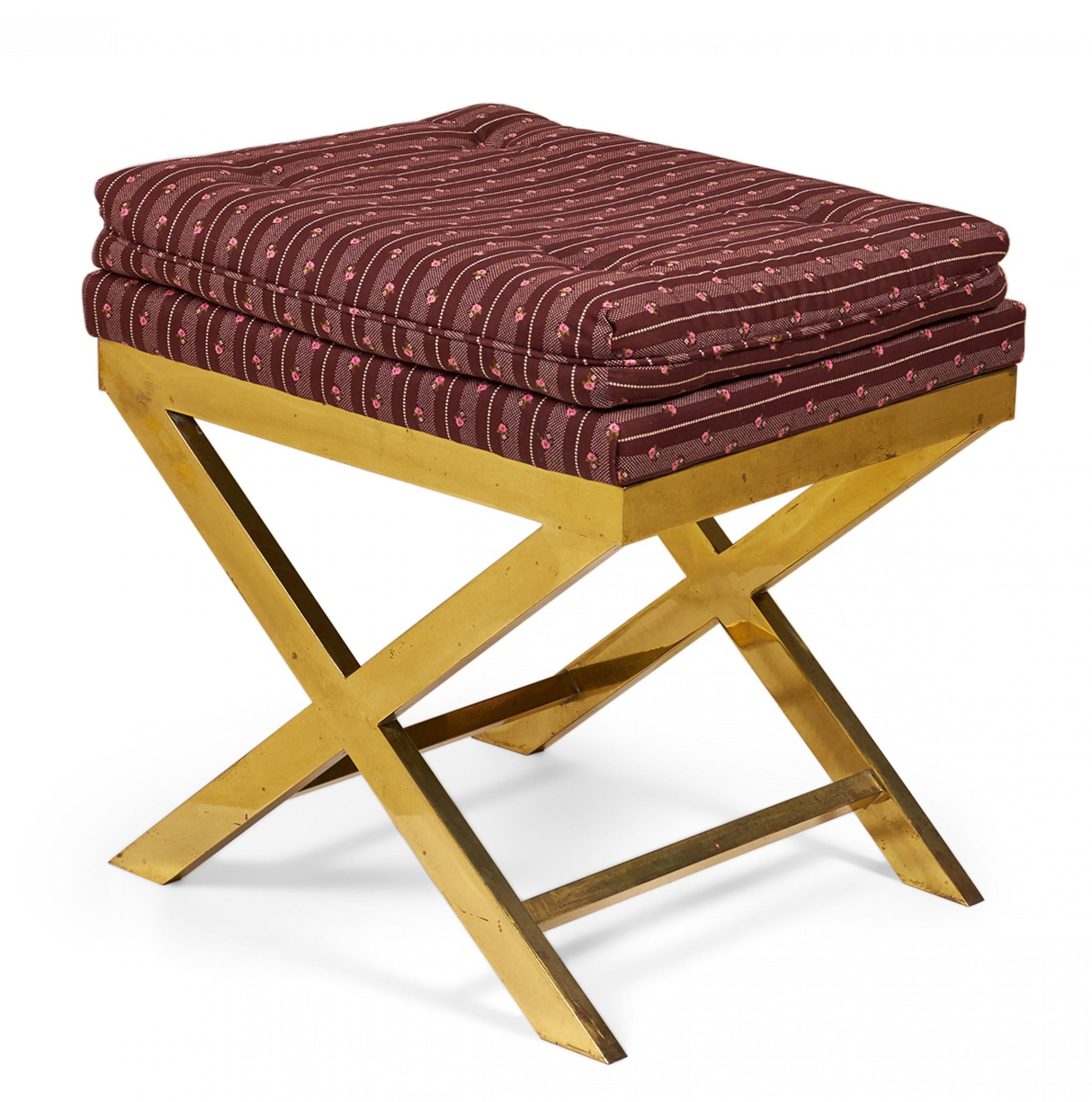 Mid-century x-bench with a brass frame topped with a striped maroon upholstered seat.
 