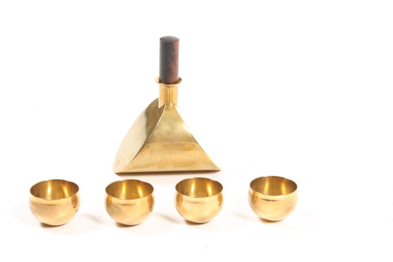 Set of bottle and 4 glass in brass designed by Pierre Forssell and made by Skultuna in Finland.