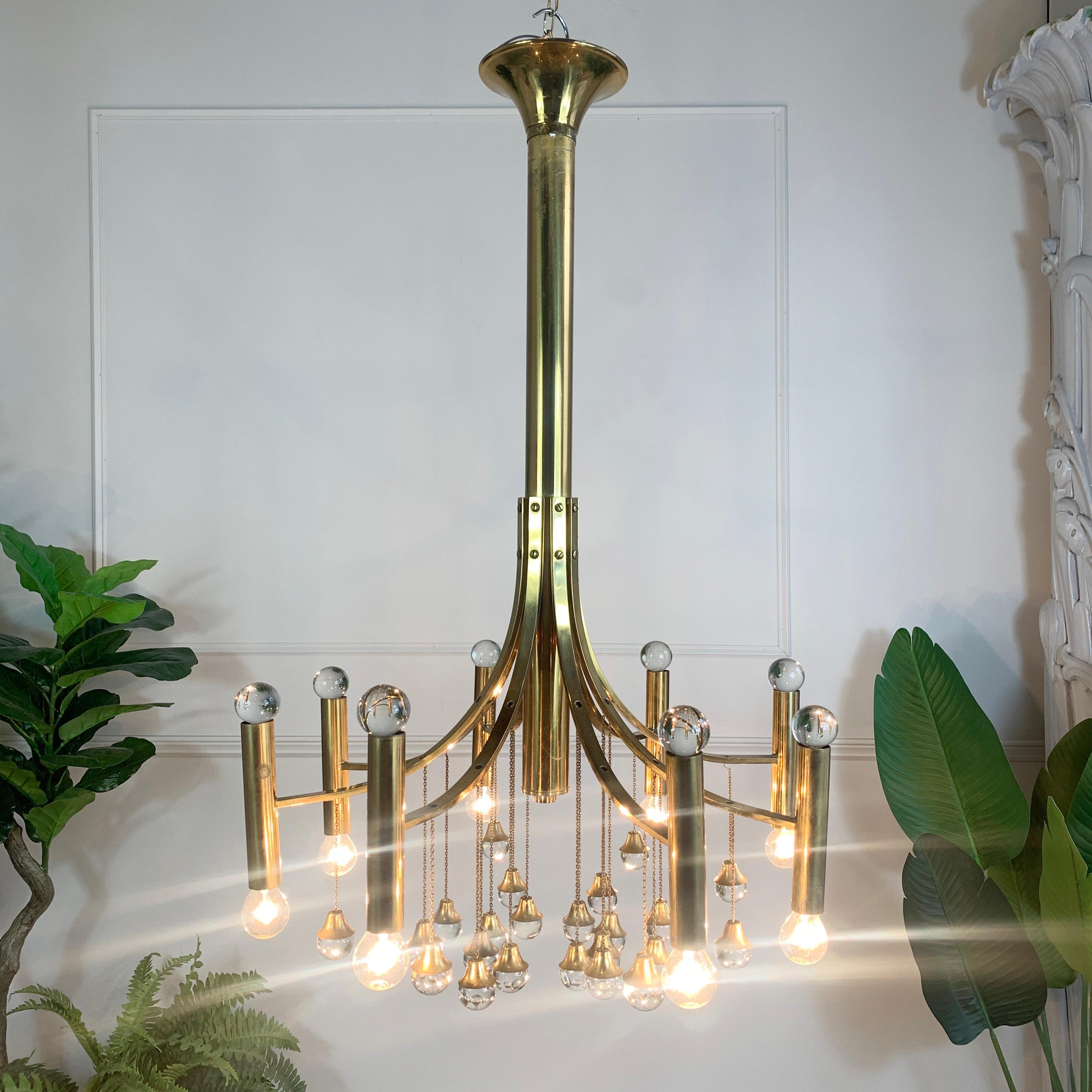 Mid-century brass chandelier
Stunning chandelier by Gaetano Sciolari, by Sciolari Lighting 1960s
The chandelier has 8 brassl arms topped with crystal spheres, eight arms hold a single bulb each, with E14 lamp holders. 

Chandelier 93cm height,