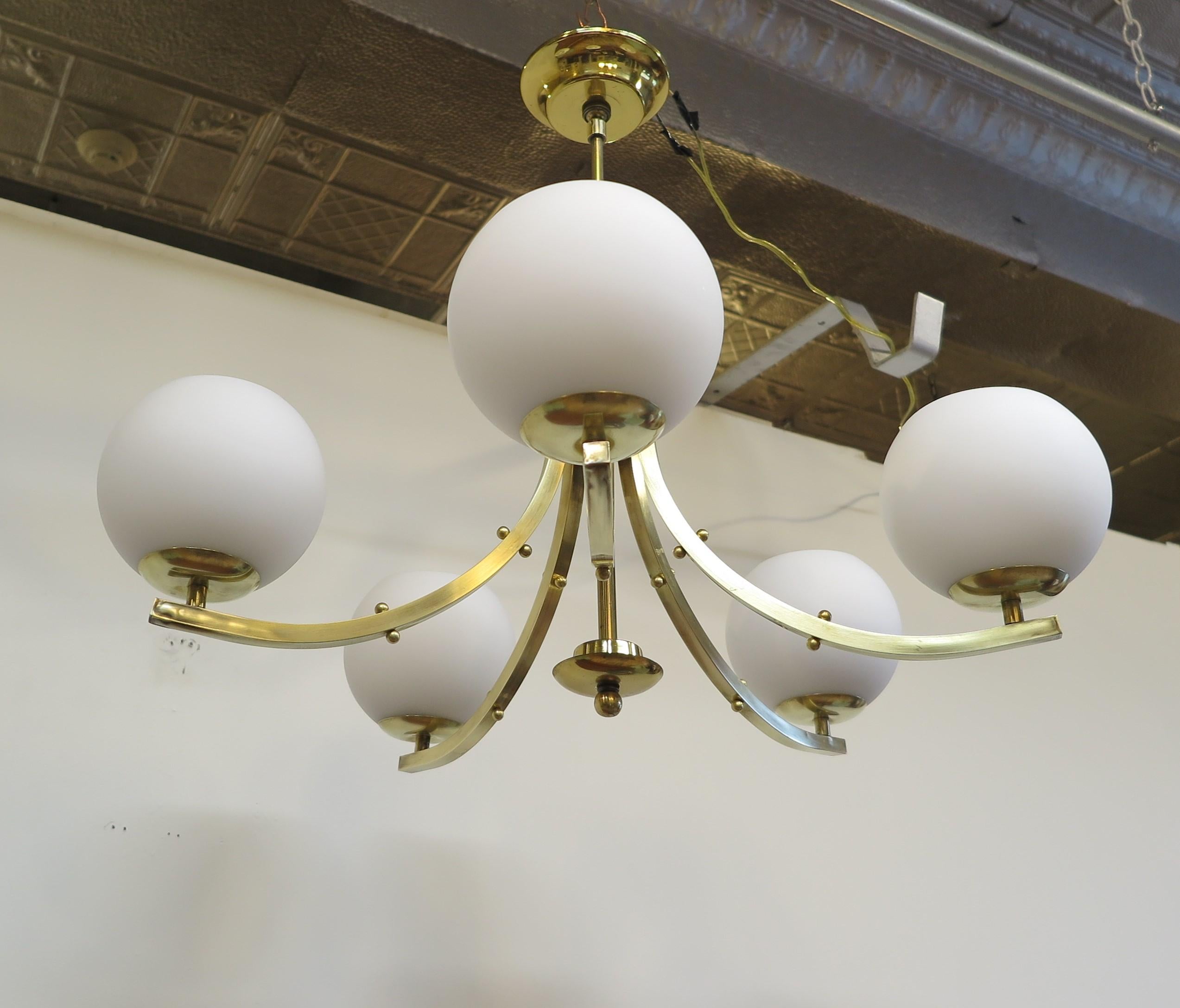 Stunning Mid-Century Modern Brass Chandelier. Lightolier Five Arm Brass Chandelier with frosted white glass sphere shaped shades. Five Arm Brass Mid-Century Modern Sphere Glass Chandelier. Five upswept square brass tube arms with small brass ball