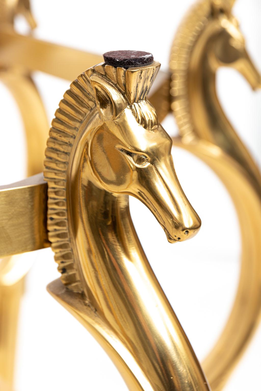 Midcentury brass cheval horse dining table attributed to Maison Jansen. Please note of wear consistent with age.