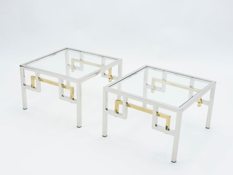 Simple lines point to these end tables midcentury roots. Designed by Guy Lefèvre for Maison Jansen, they feature silky chrome legs, with brass addition, and transparent glass tops. Their symmetry, elevated glass, and Asian inspired and strong