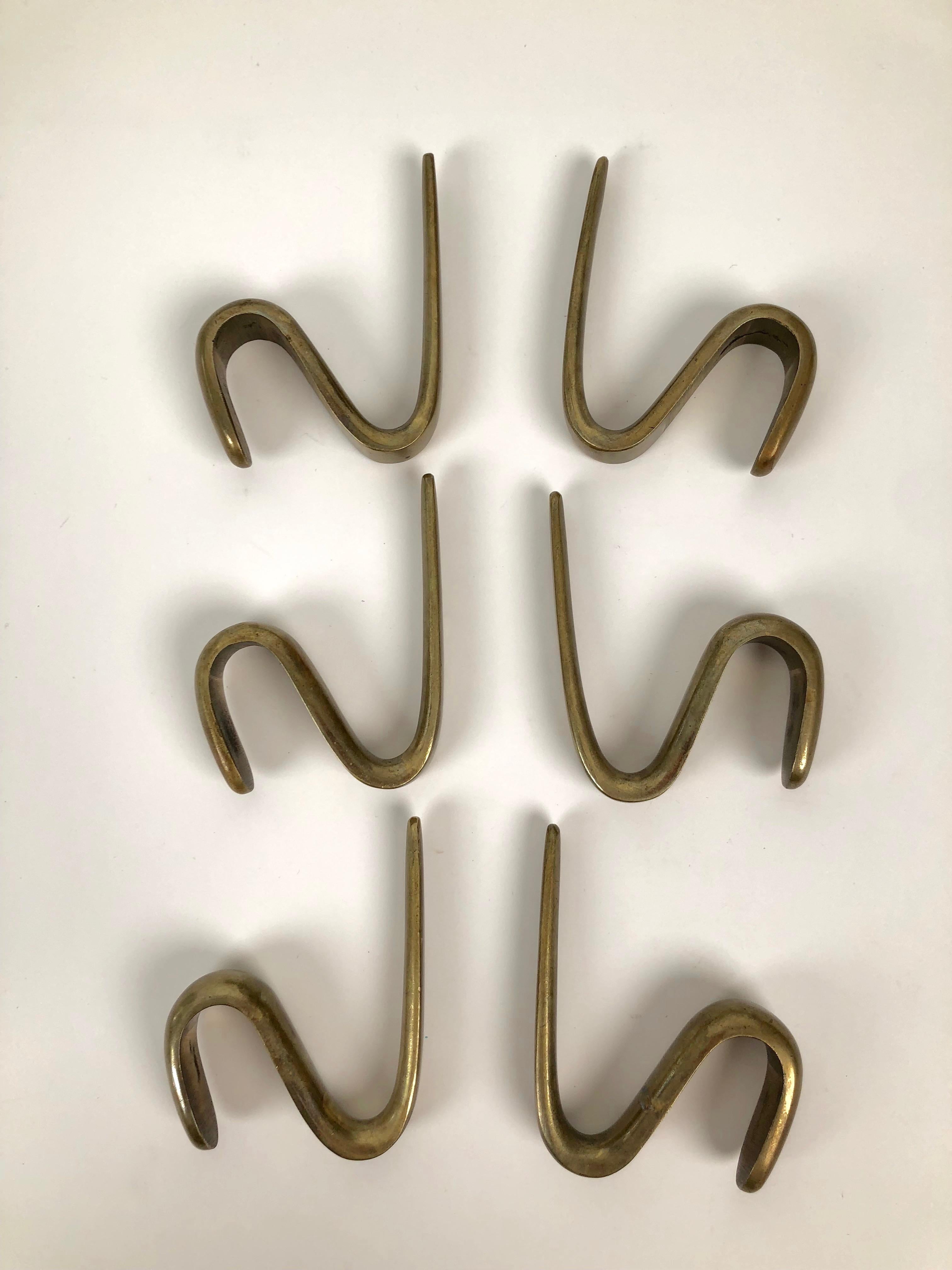 Six midcentury brass coat rack hooks from the 1950s. Based on the catalog, the hooks
were produced between 1950-1959.