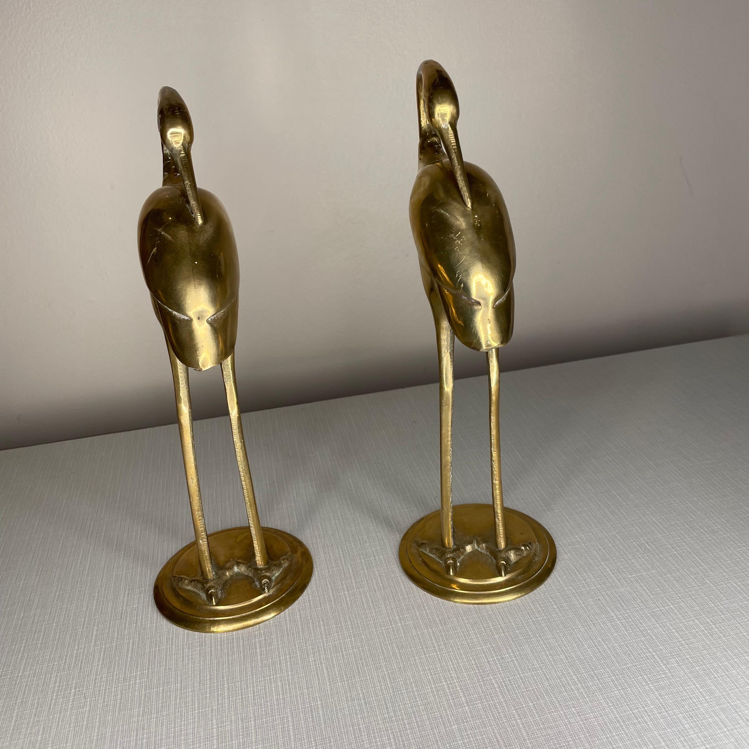 Vintage pair of brass cranes or egrets. Both are in exceptional condition. Perfectly matching. Would look great on a bookshelf or to add to your current brass collection!