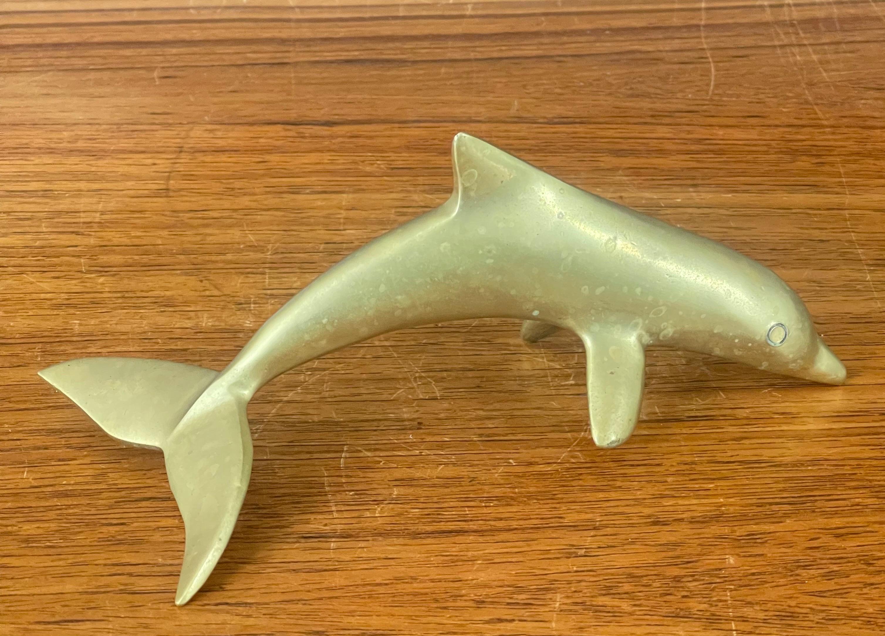 A very nice mid-century brass dolphin sculpture/ paperweight, circa 1970s. The piece is in very good vintage condition with a nice patina and measures 7.5